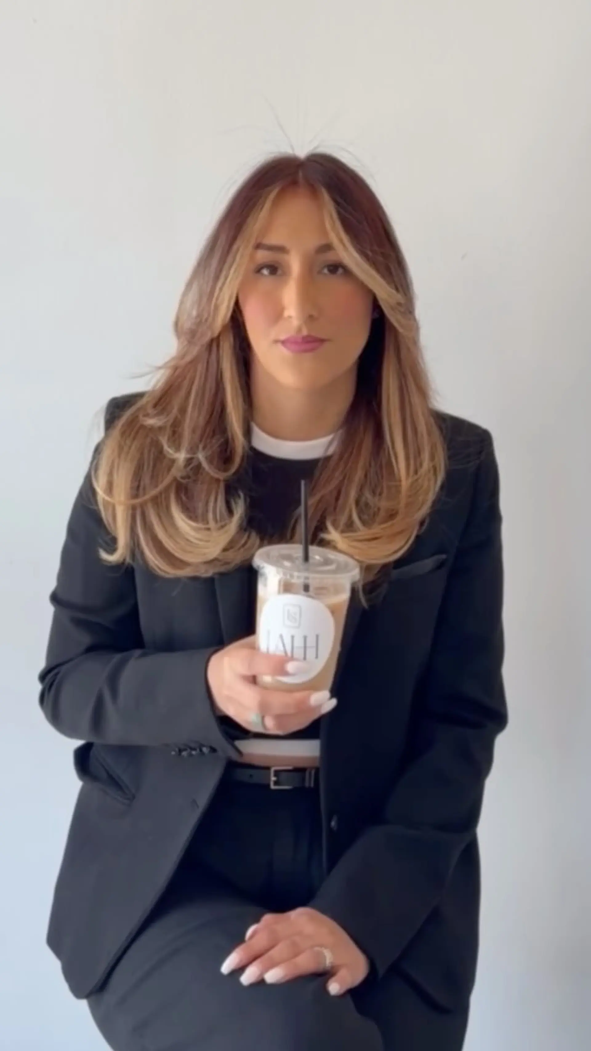 A voluminous layered blowout with curved ends and bright blonde face-framing highlights. 1