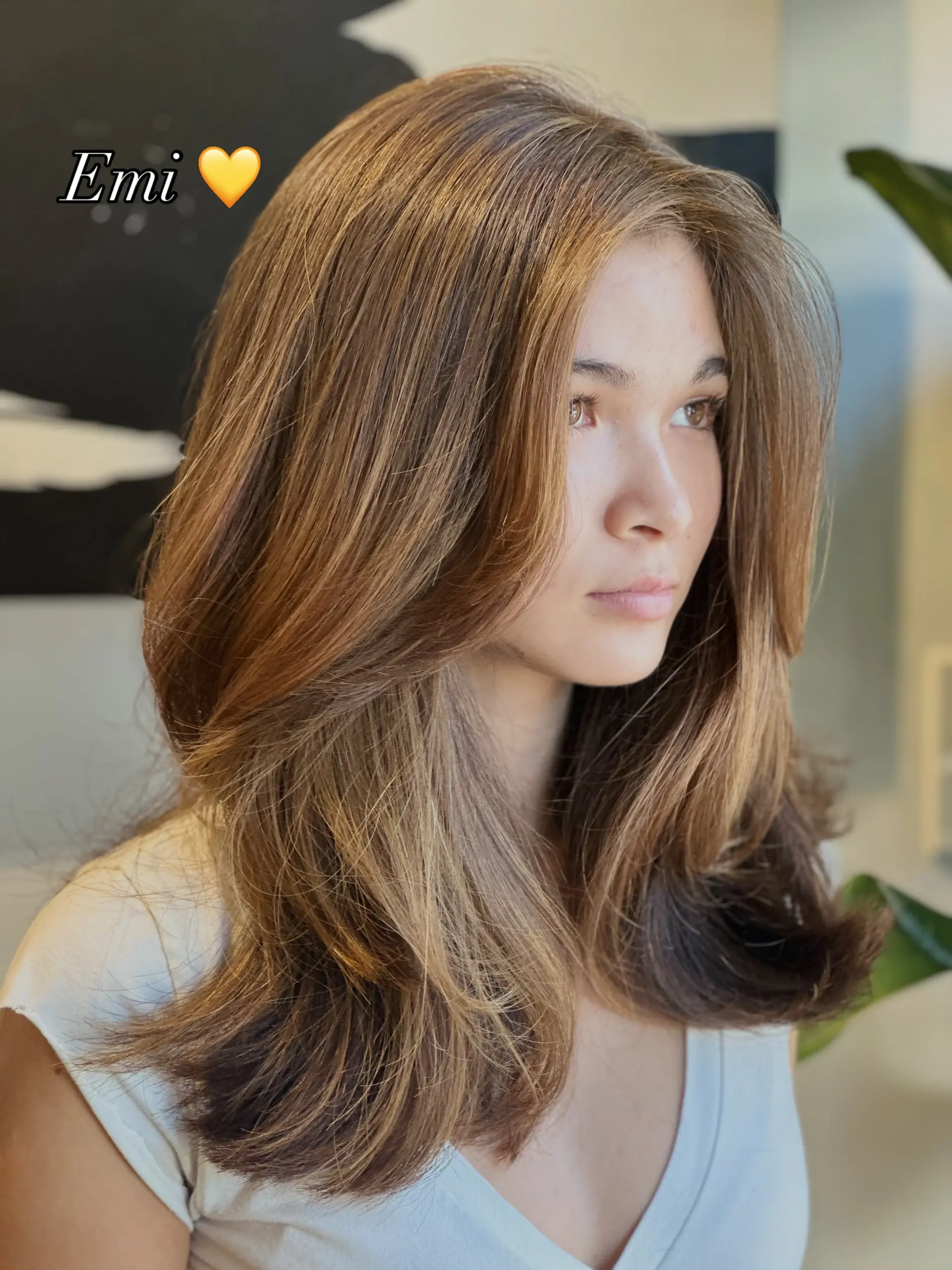 Long light brown hair featuring bouncy, face-framing layers and soft, natural caramel highlights. 1