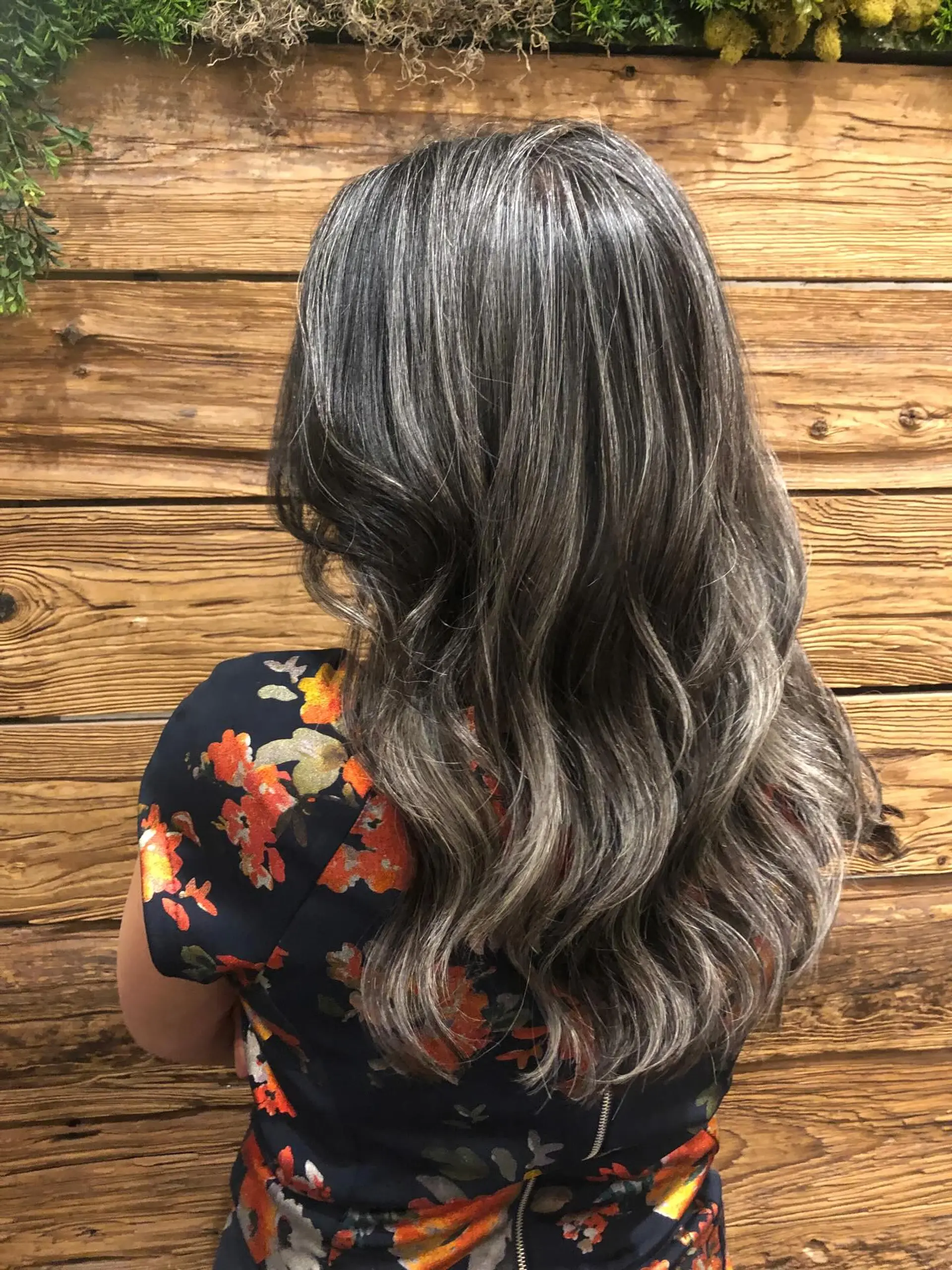 Long natural silver and charcoal hair styled in loose, soft waves cascading down the back. 1