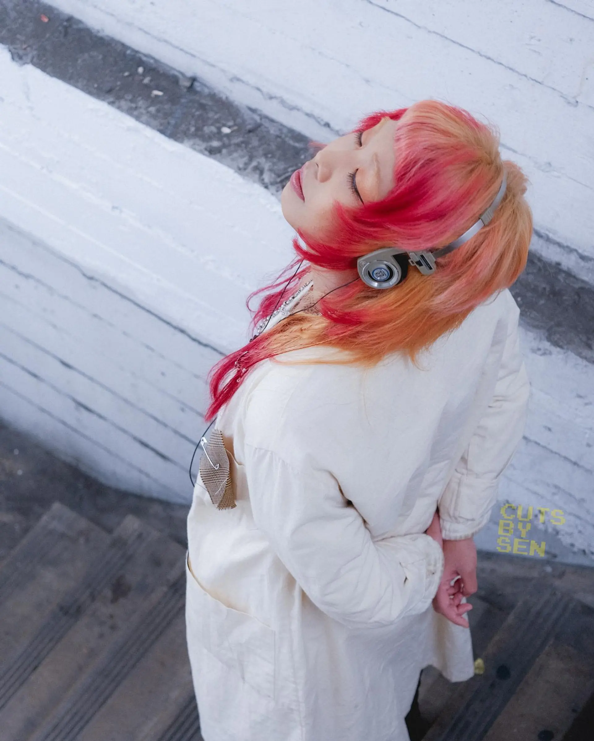 A modern, edgy take on the Japanese hime cut featuring blunt-cut cheekbone-length layers, short textured bangs, and longer choppy layers rendered in vivid pink and peach tones. 1