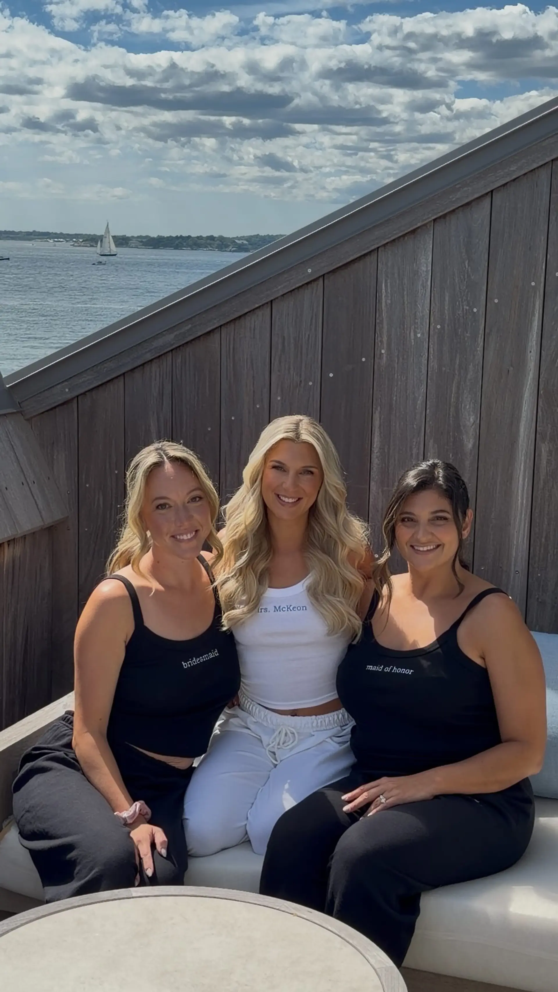 Bridal party hairstyles featuring cascading blonde waves for the bride and effortless formal updos with face-framing tendrils for the bridesmaids. 1