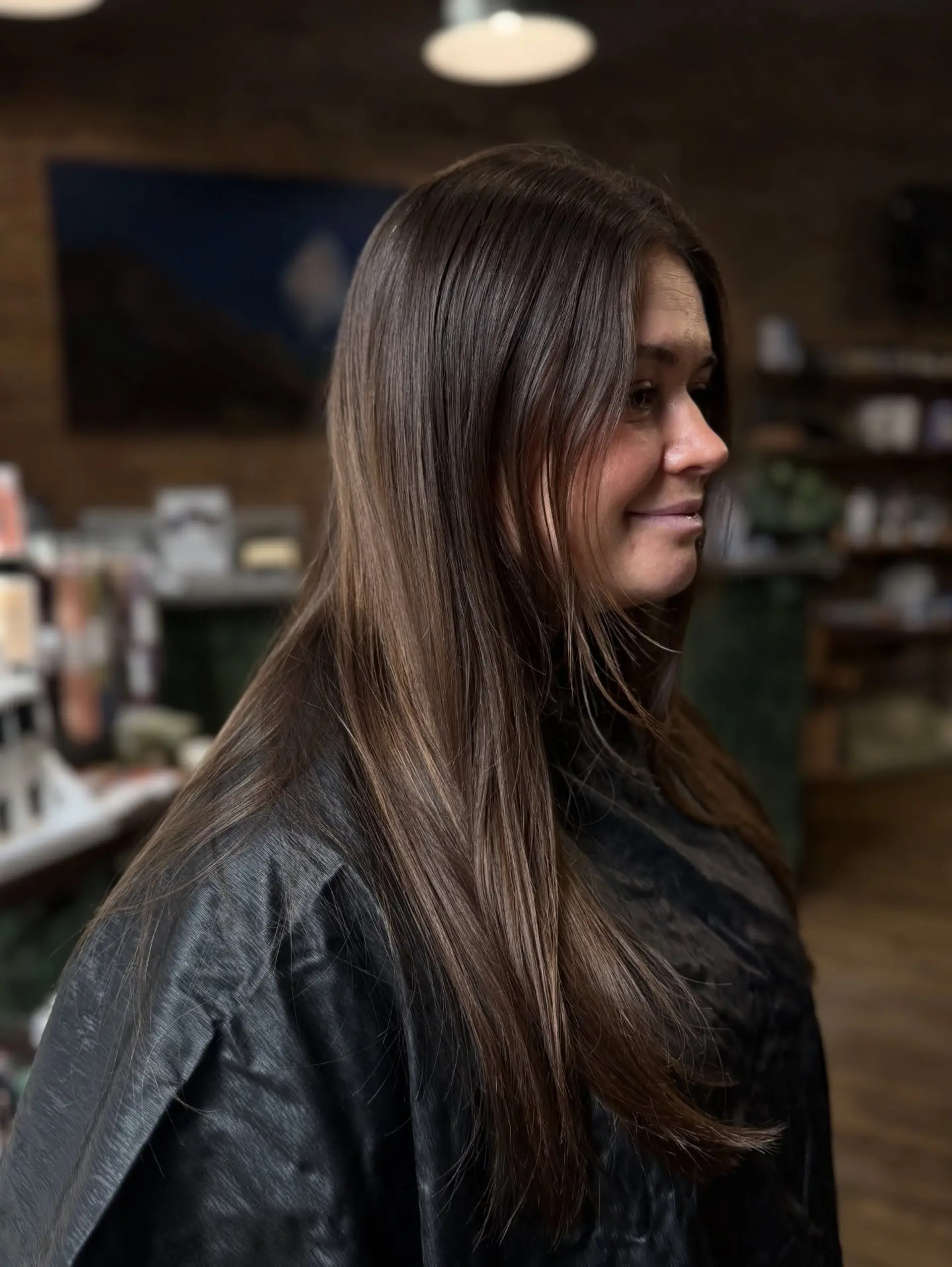 Long, smooth straight brunette hair styled with subtle face-framing layers and a glossy finish. 1