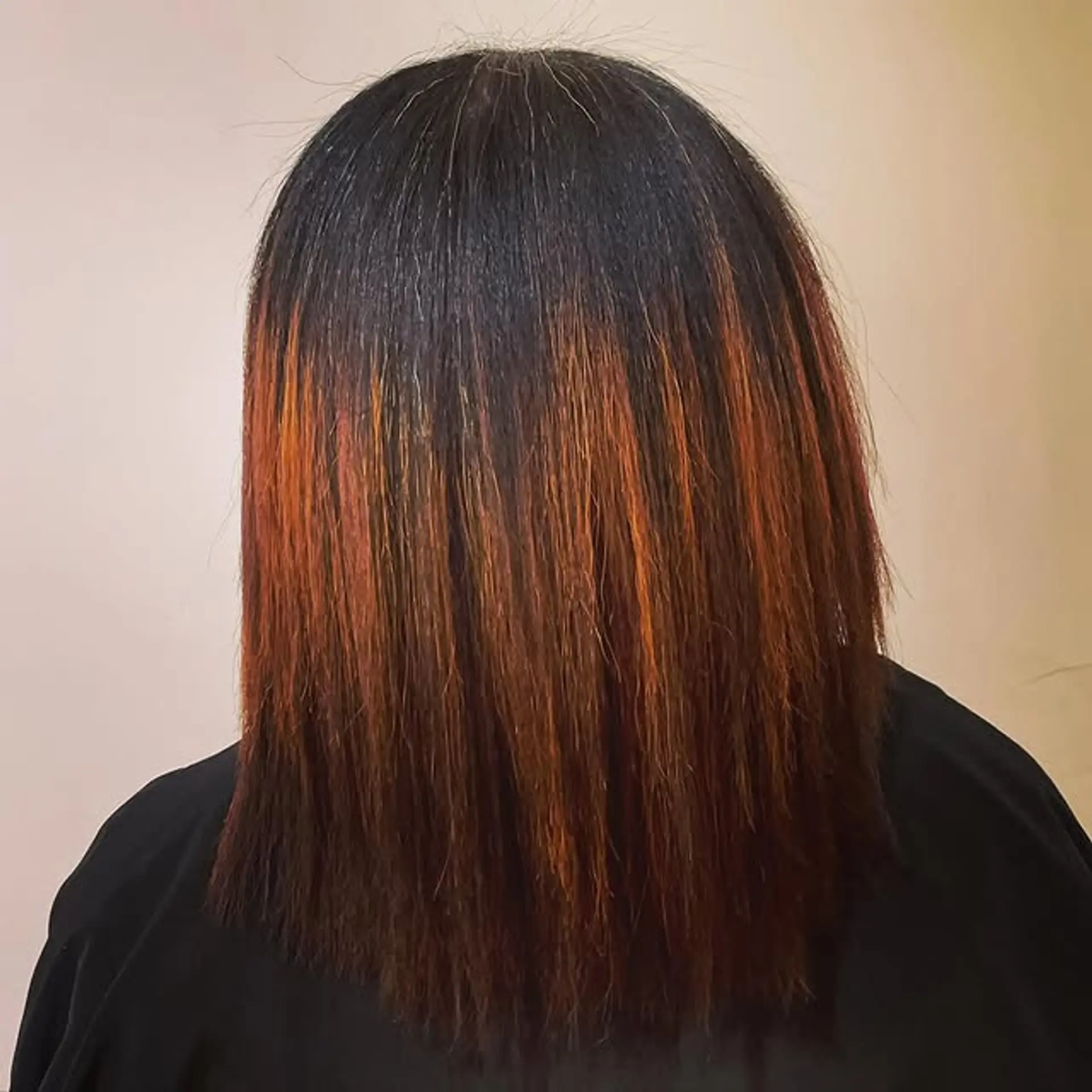 A sleek, straight lob with dark shadow roots and bronze-auburn highlights. 1