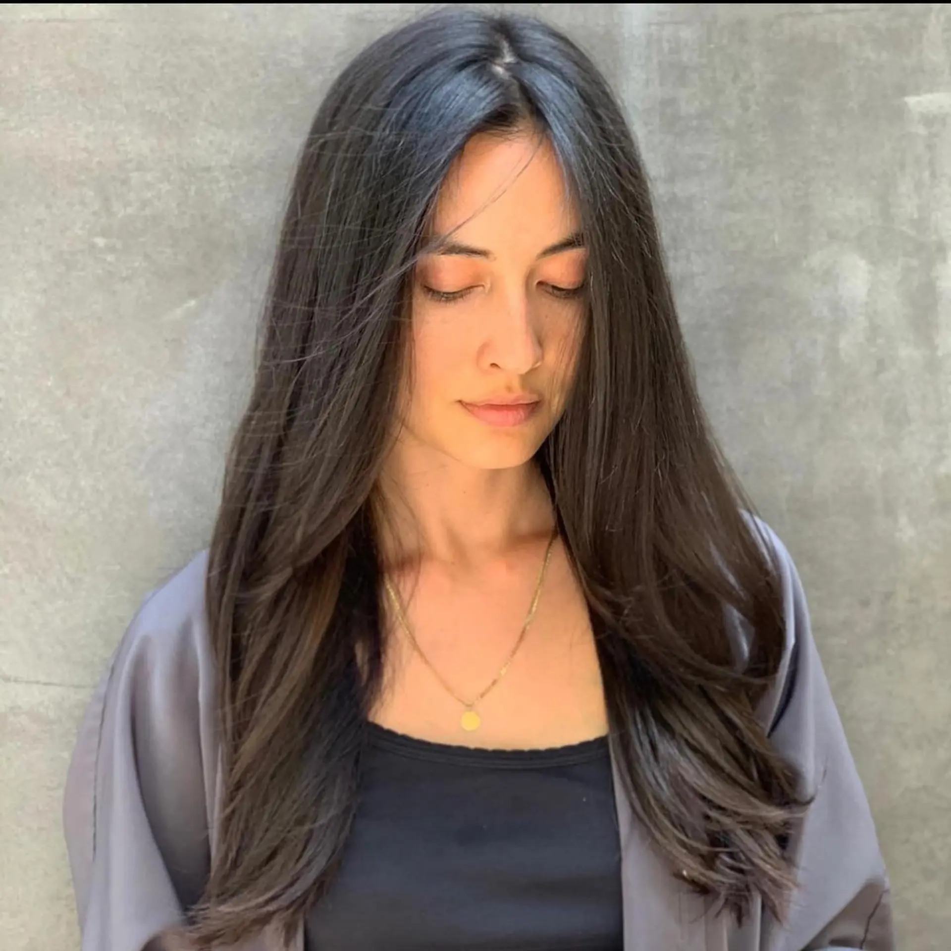 Long espresso brunette hair styled with smooth layers and soft face-framing sections. 1