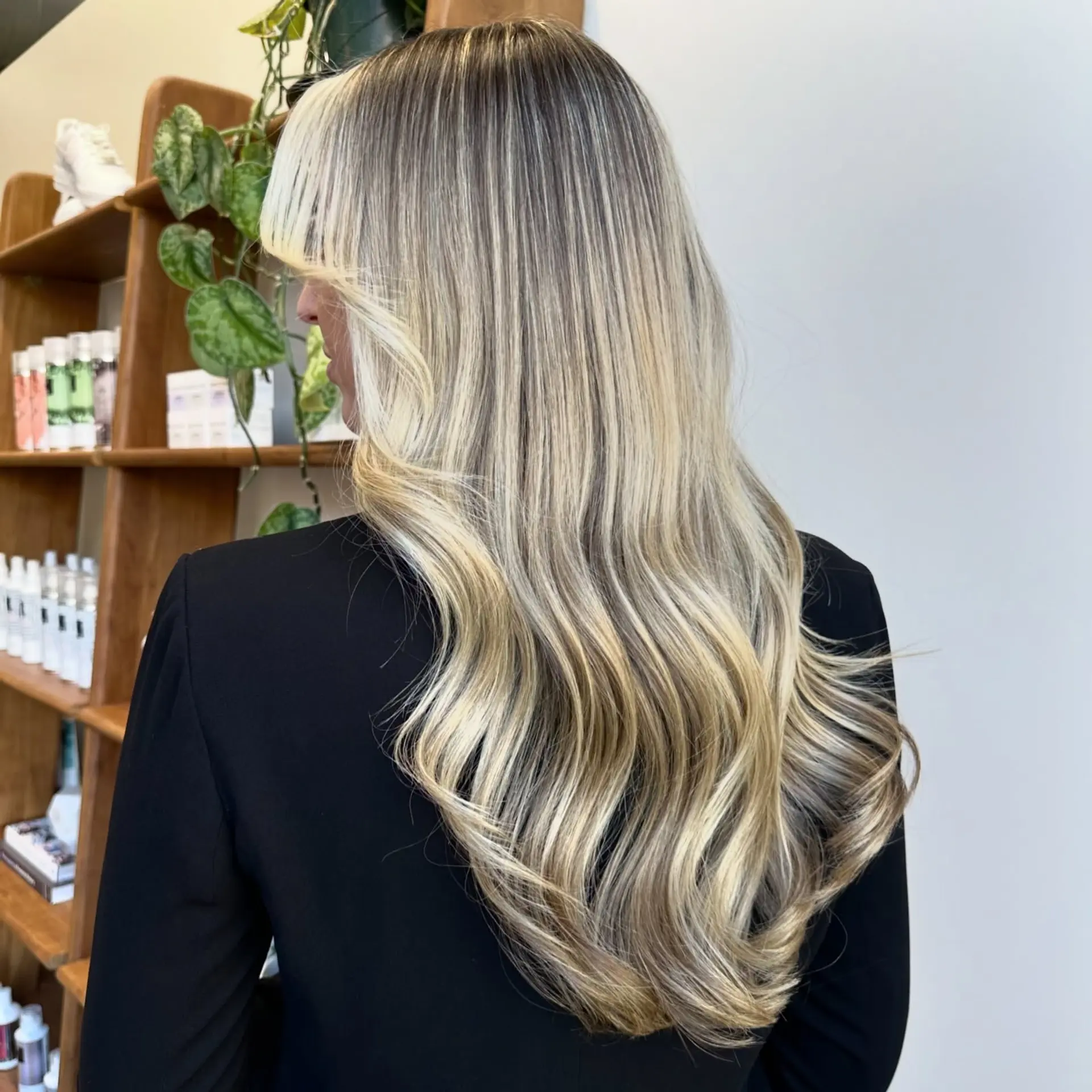 Long blonde balayage with face-framing bangs and soft waves. 1