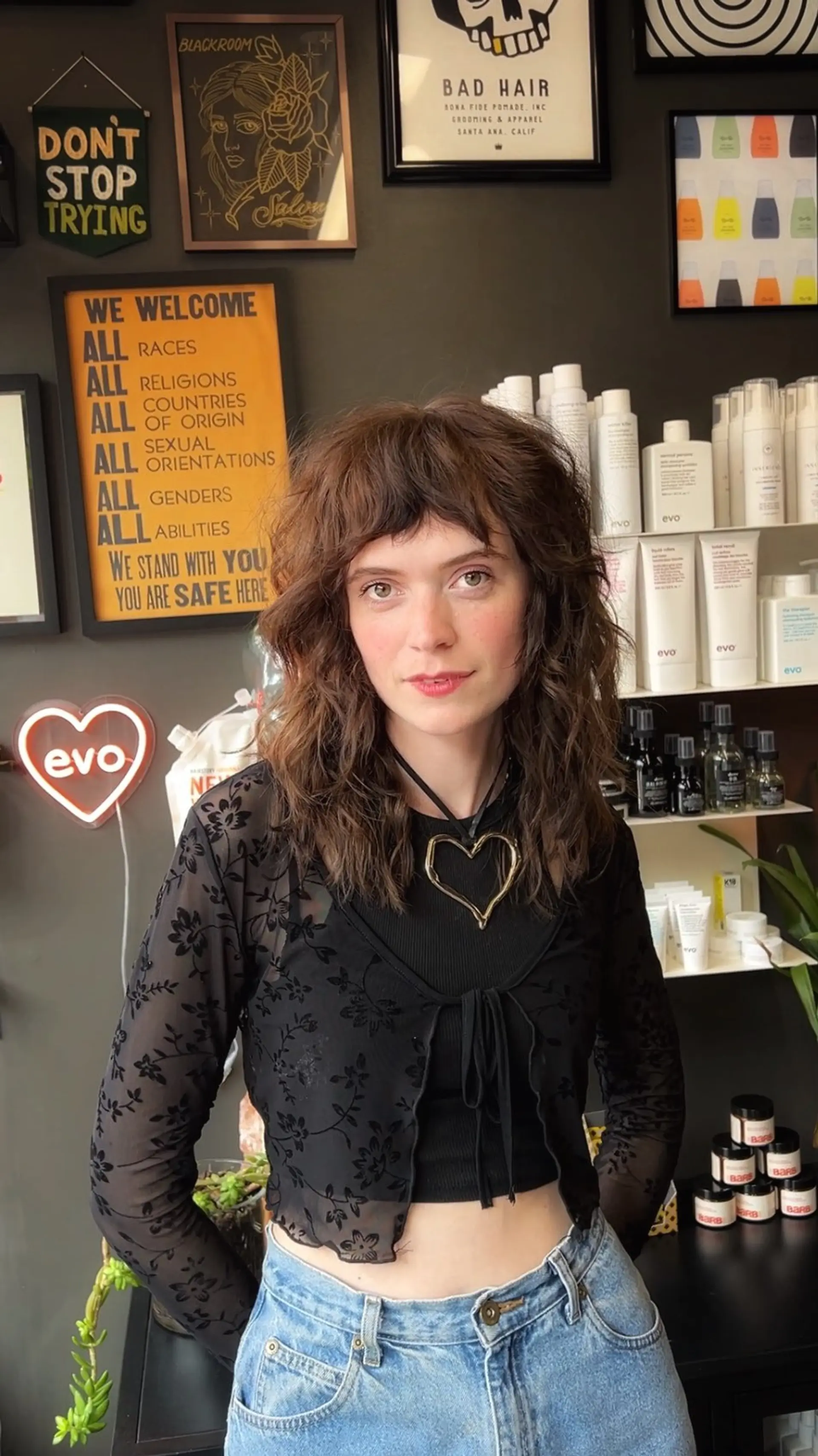 A mid-length textured shag featuring heavy razored layers, wavy volume, and piecey, brow-grazing bangs. 1