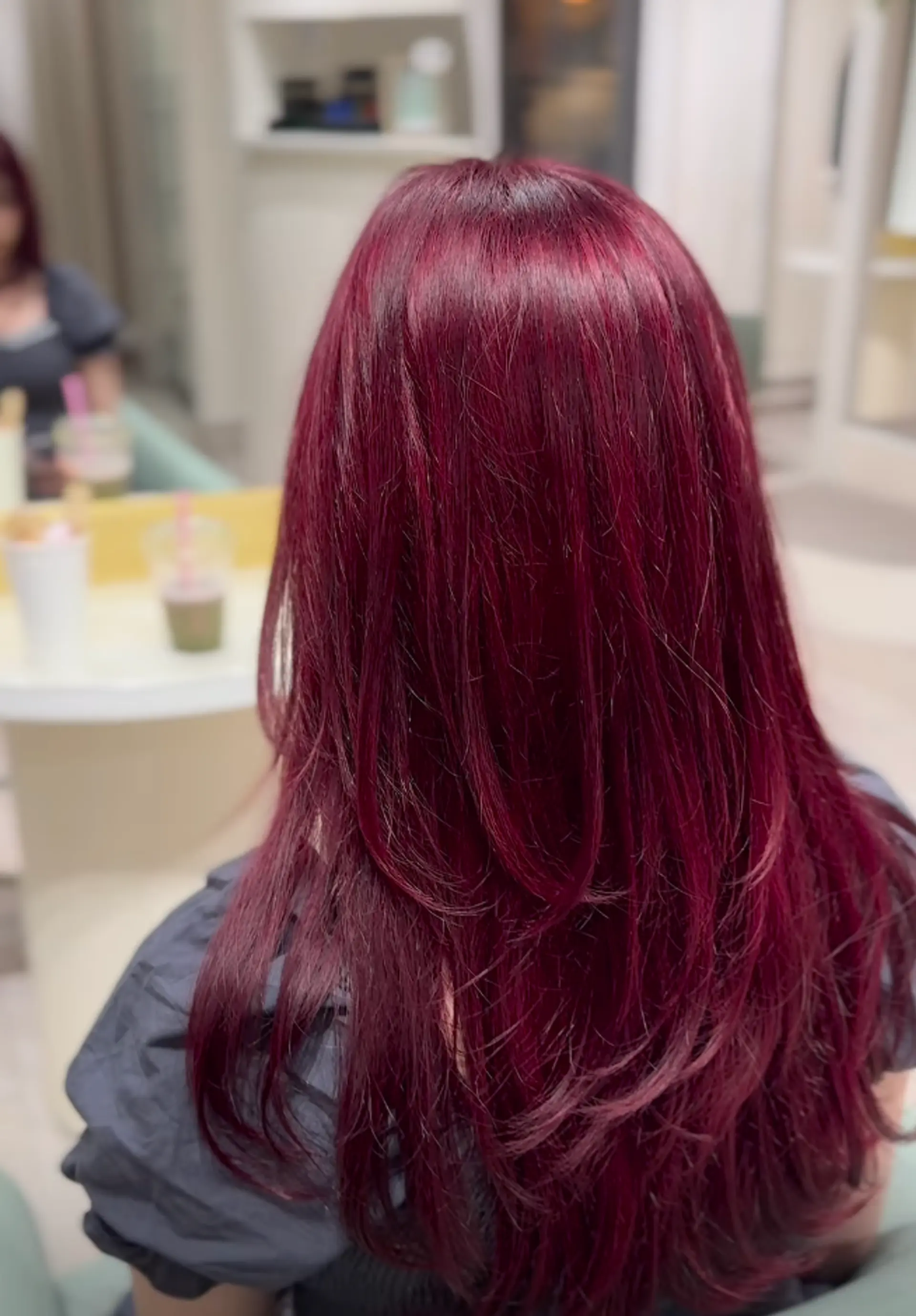 Long, straight hair with a rich, vibrant red color and layered cut for added dimension and movement. 1