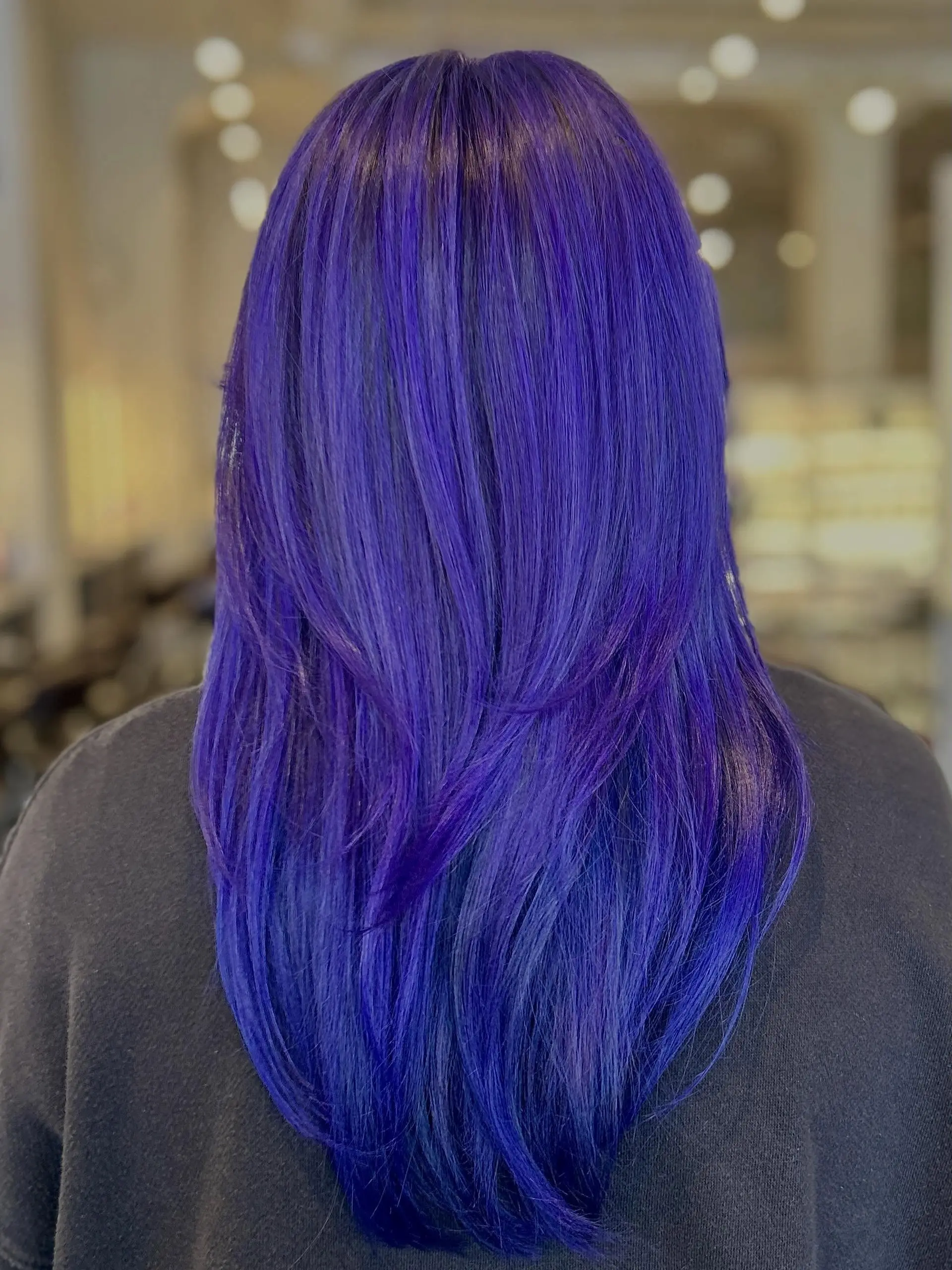 Long straight hair featuring a vivid purple-indigo hue with layered styling. 1