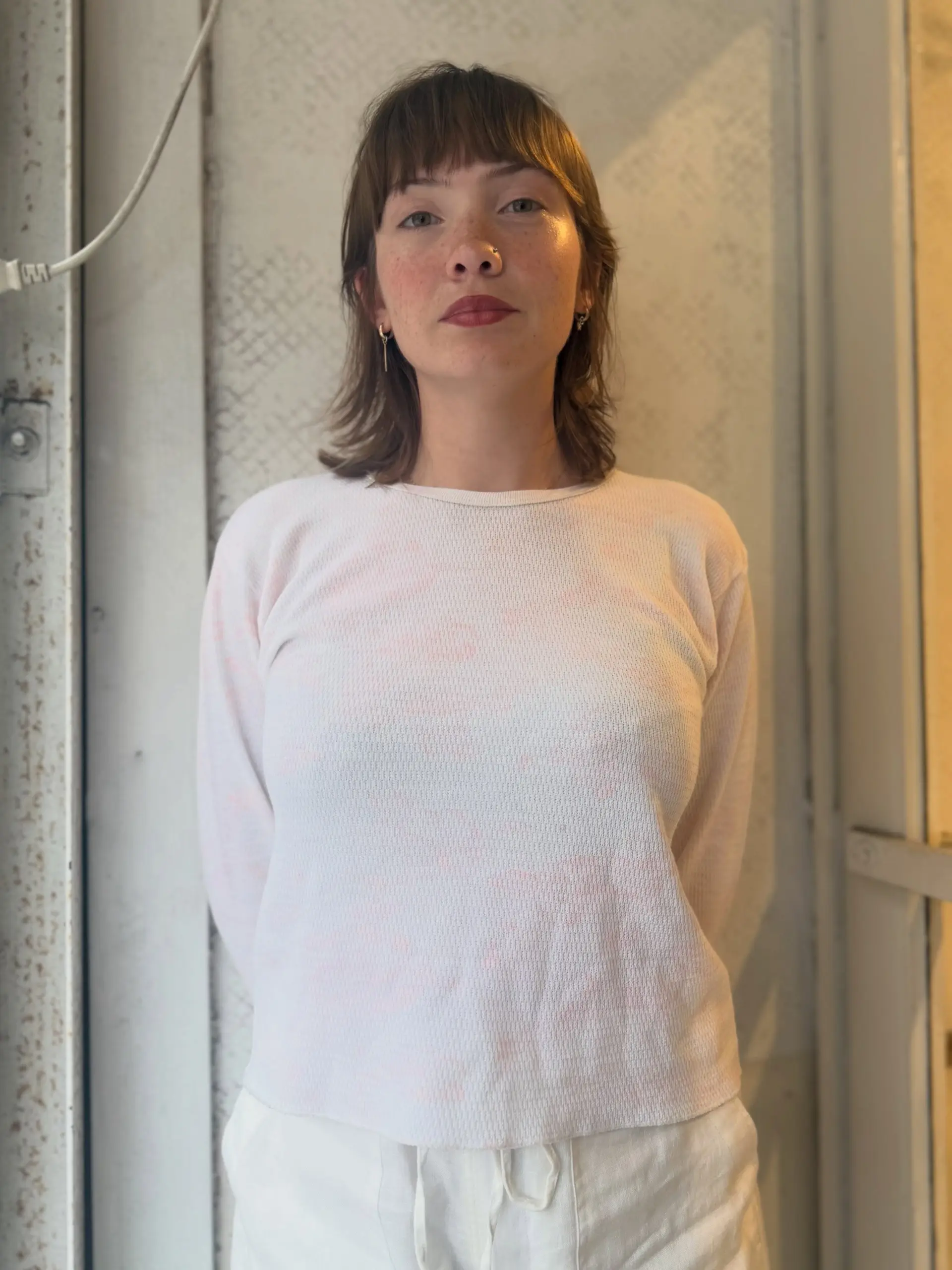 A soft layered shag cut hitting the collarbones with straight, piecey bangs. 1