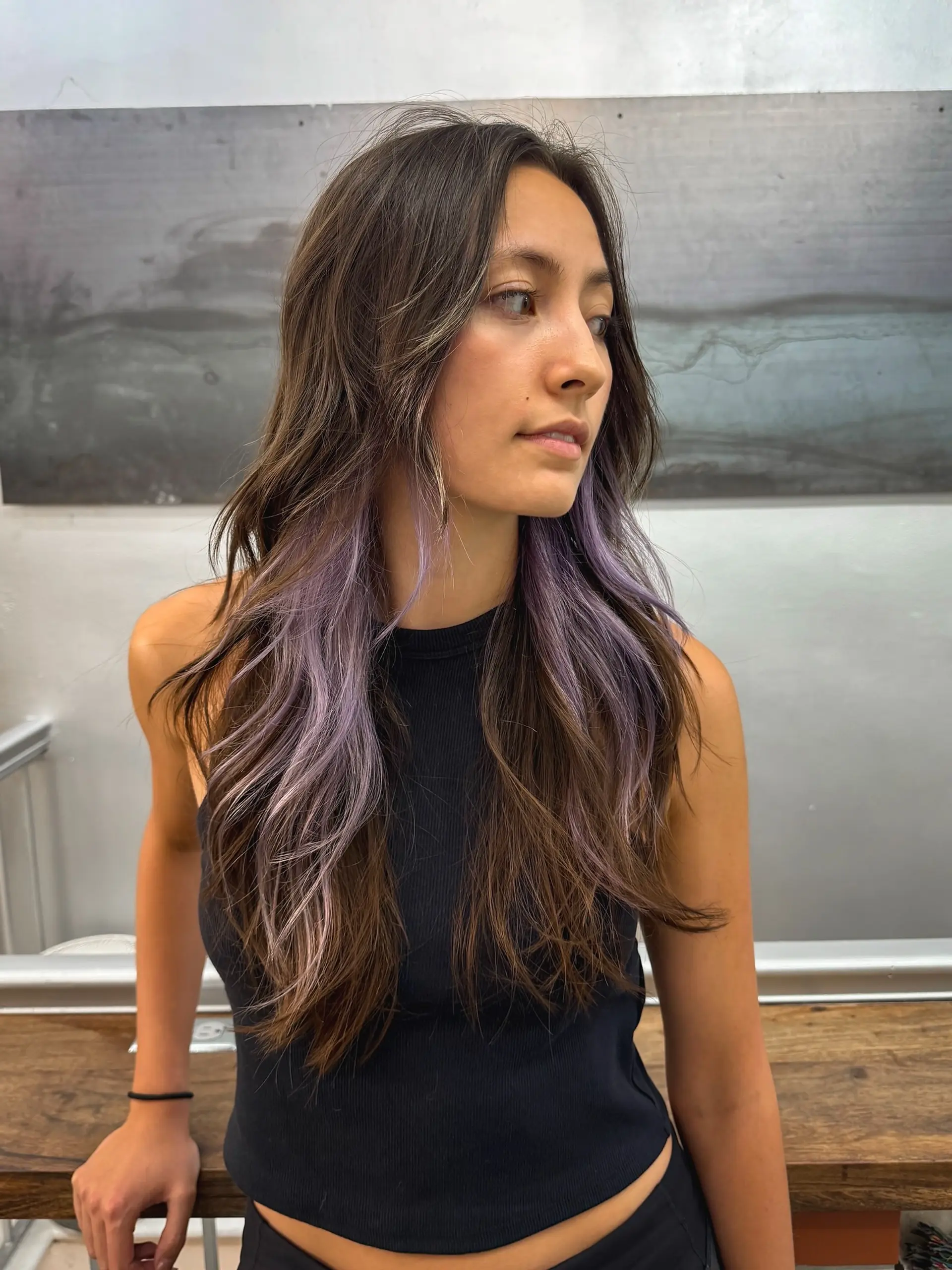 Long layered haircut with lilac money piece highlights. 1