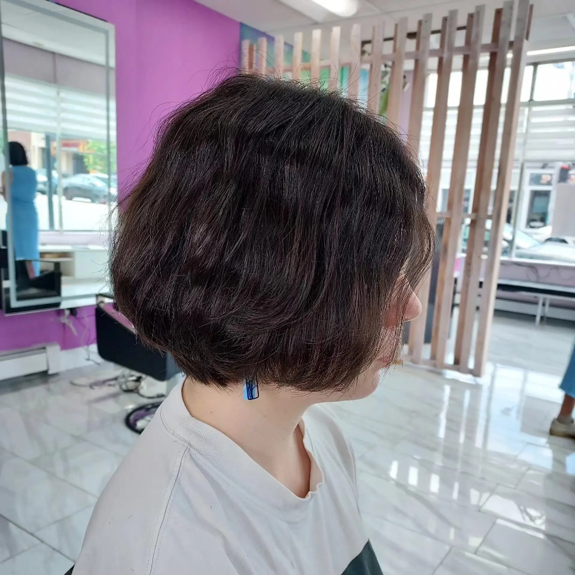 A textured chin-length dark brown bob cut with soft interior layering and subtle volume. 1