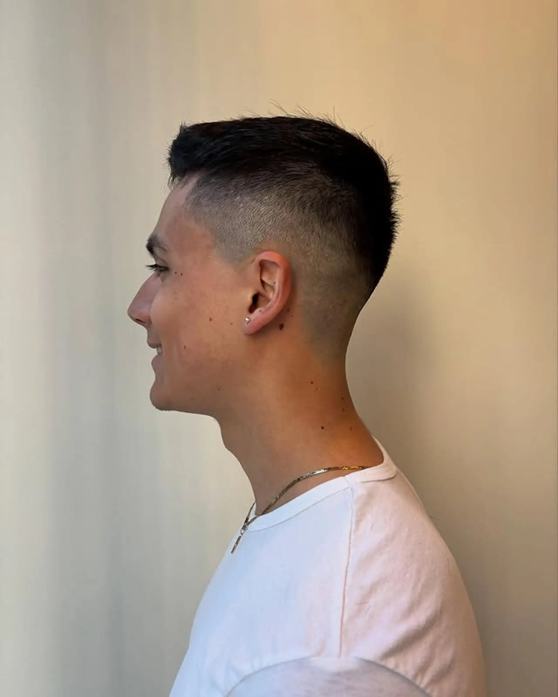 A classic taper fade with short, blended sides and slightly longer hair on top. 1