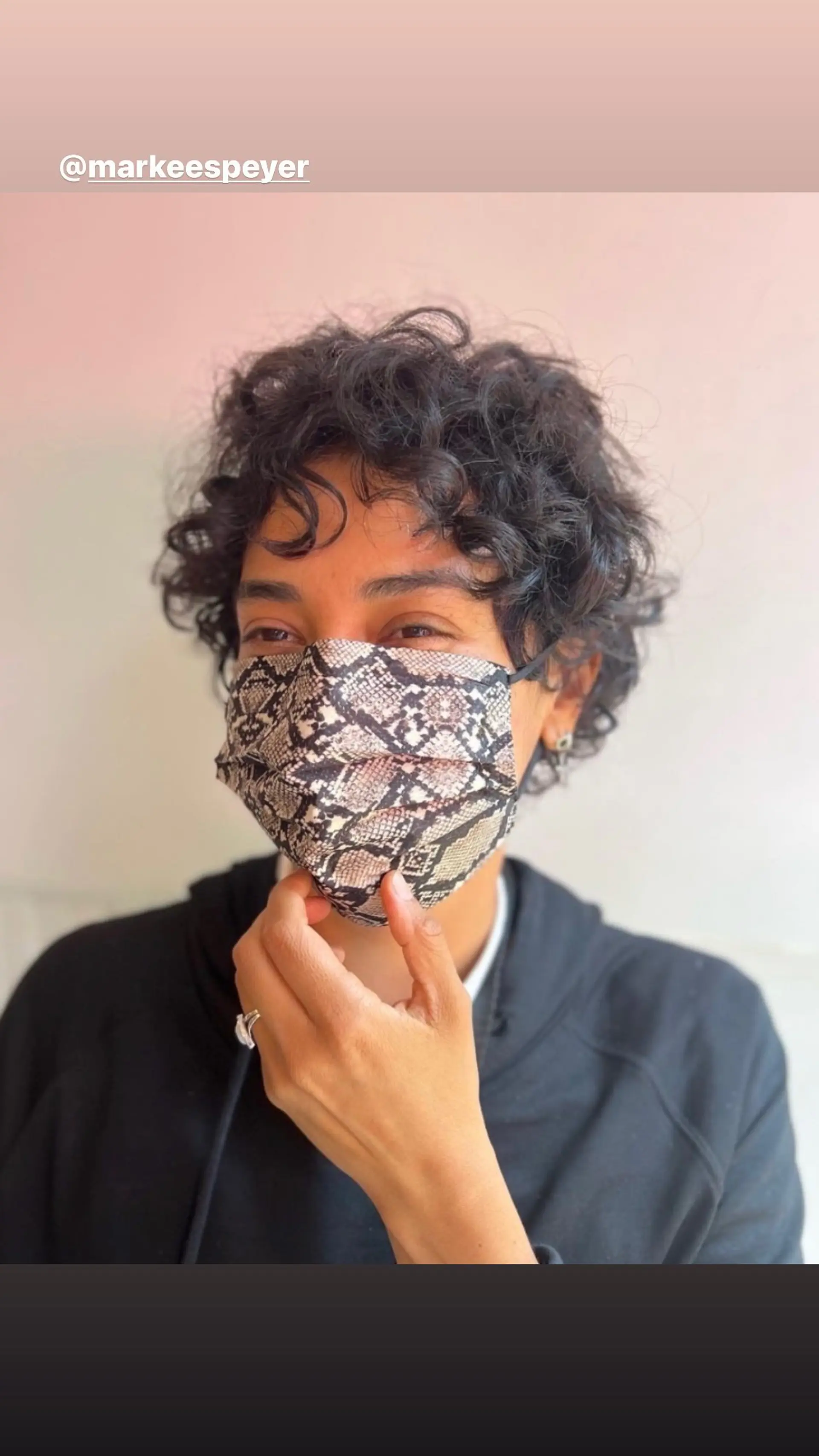 A short, curly pixie cut designed to enhance natural curls. 1