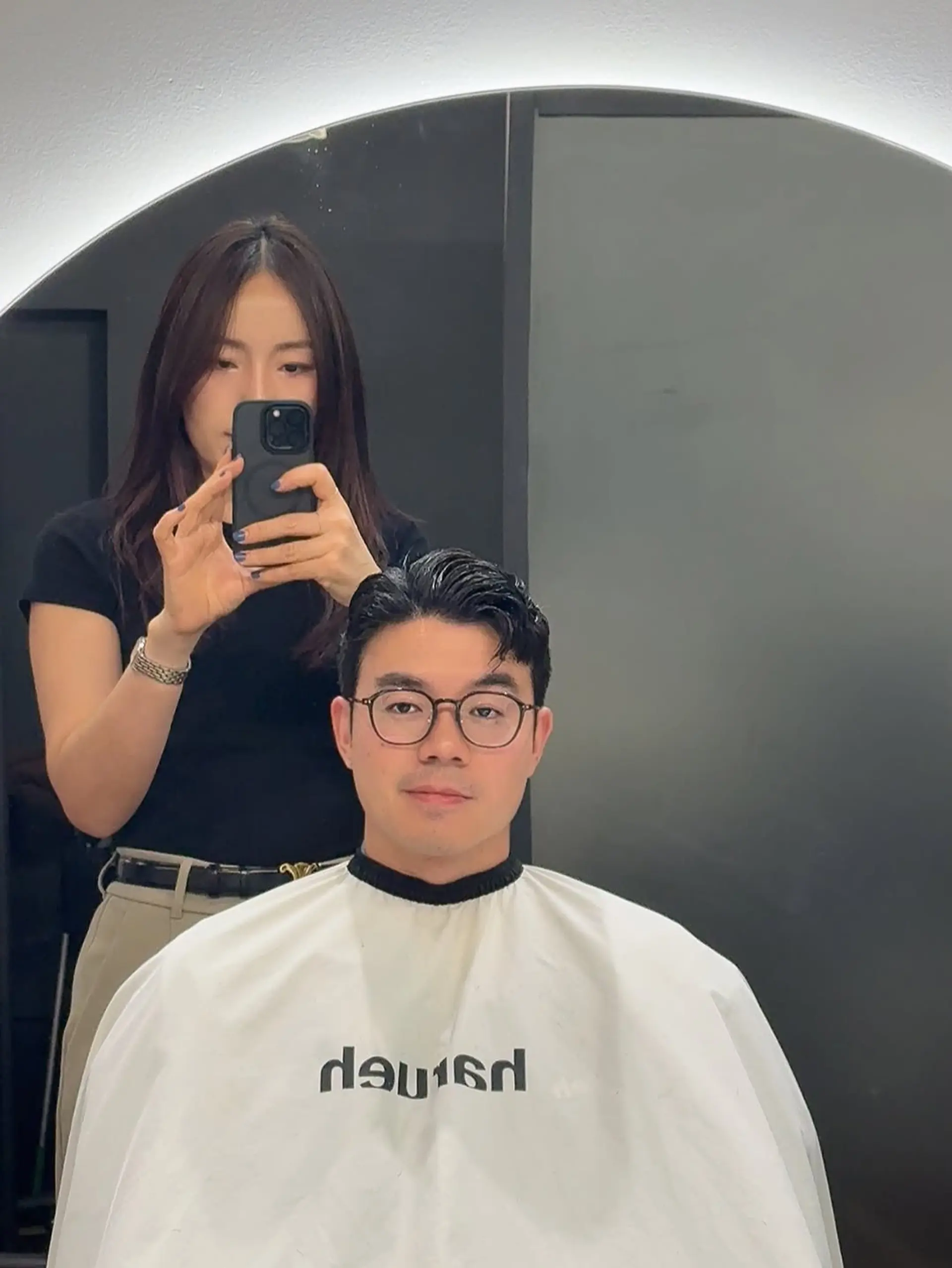 A short, versatile cut with a subtle taper on the sides and back, paired with textured, slightly parted hair on top for a neat, professional look. 1