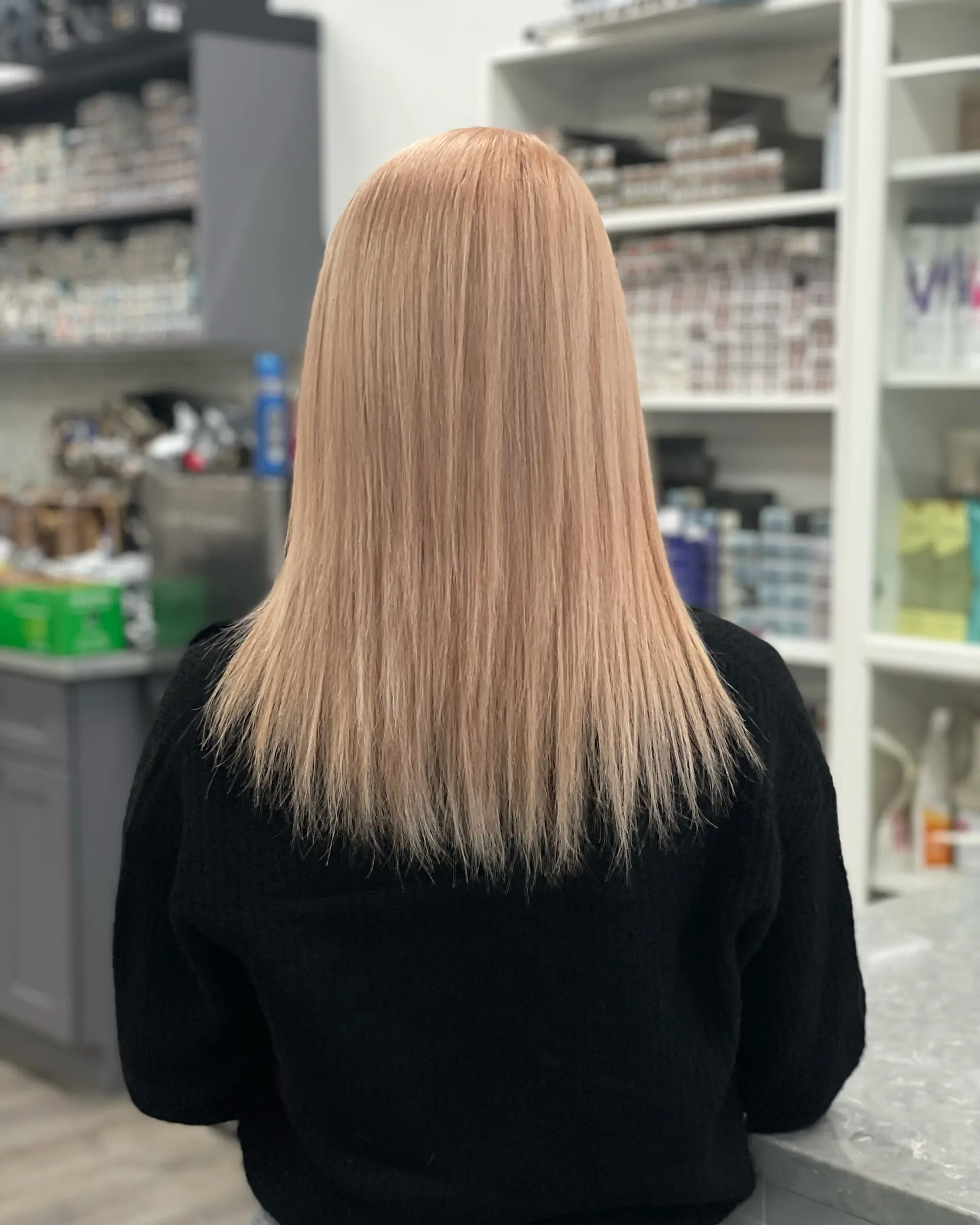 Medium-length straight hair with a subtle layered cut and a creamy buttery blonde tone. 1