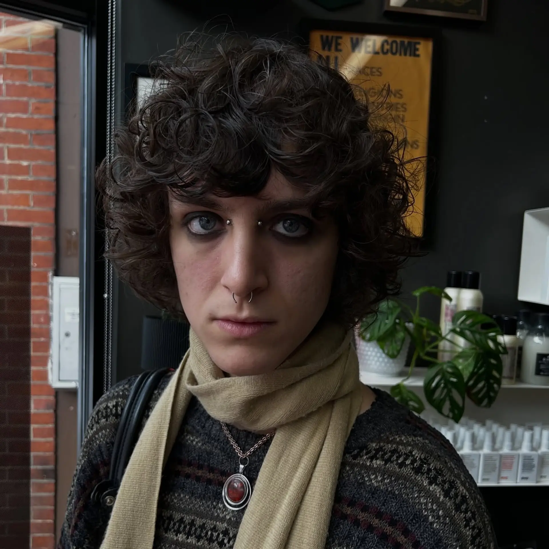 A textured short curly shag with natural ringlets and full, brow-skimming curly bangs. 1