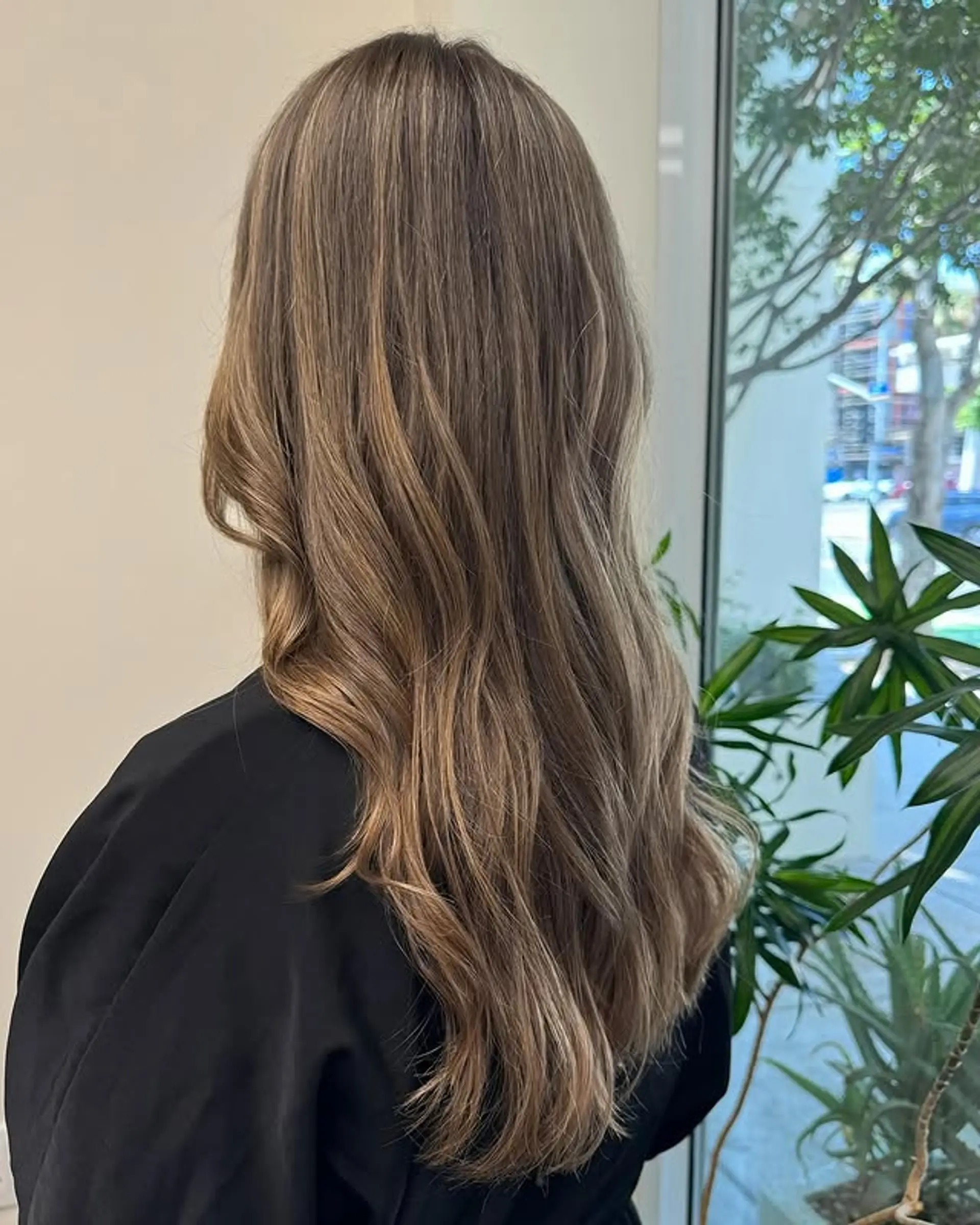 Long, wavy hair with a subtle ash blonde balayage. 1