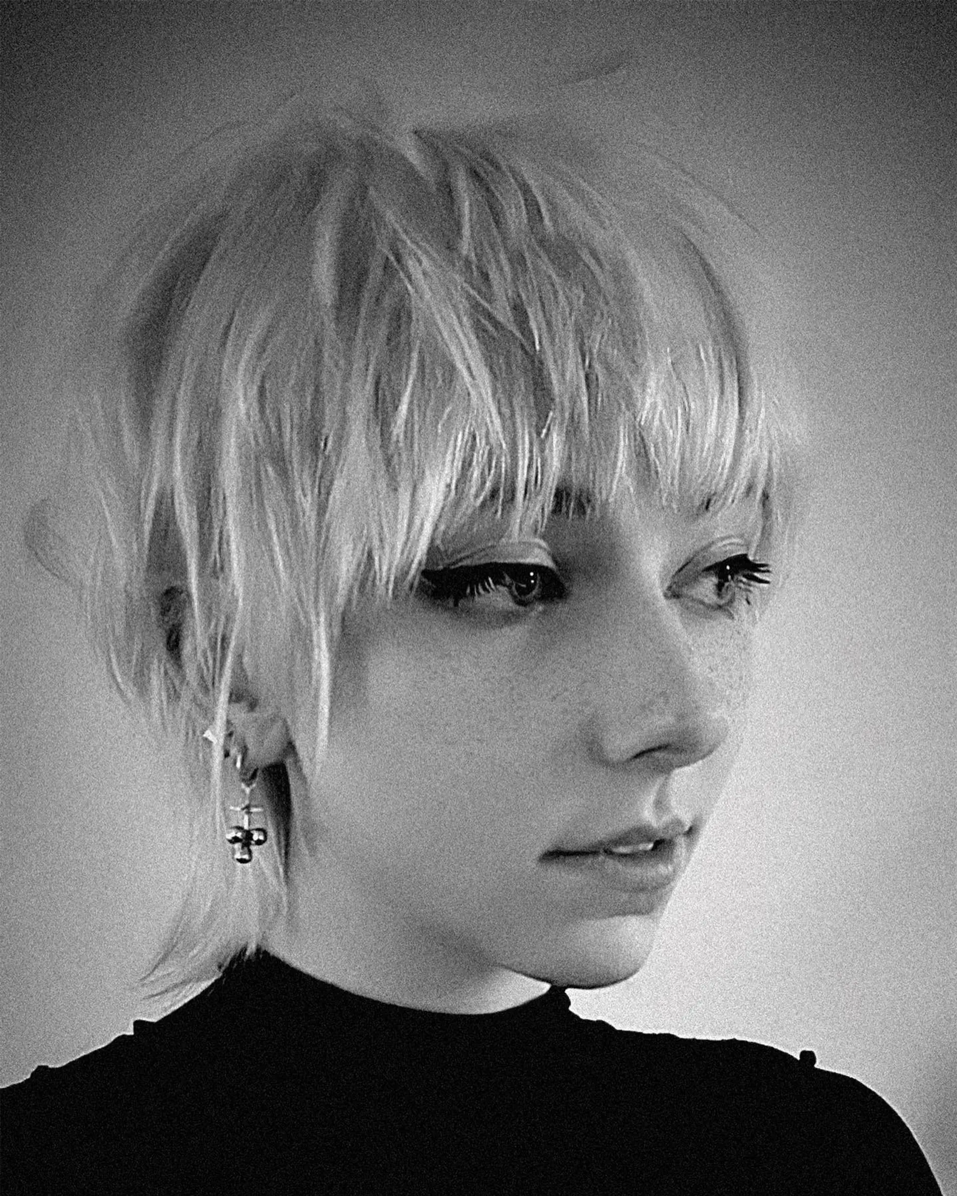 A modern, textured short shag mullet featuring choppy, face-framing layers and soft brow-skimming fringe. 1