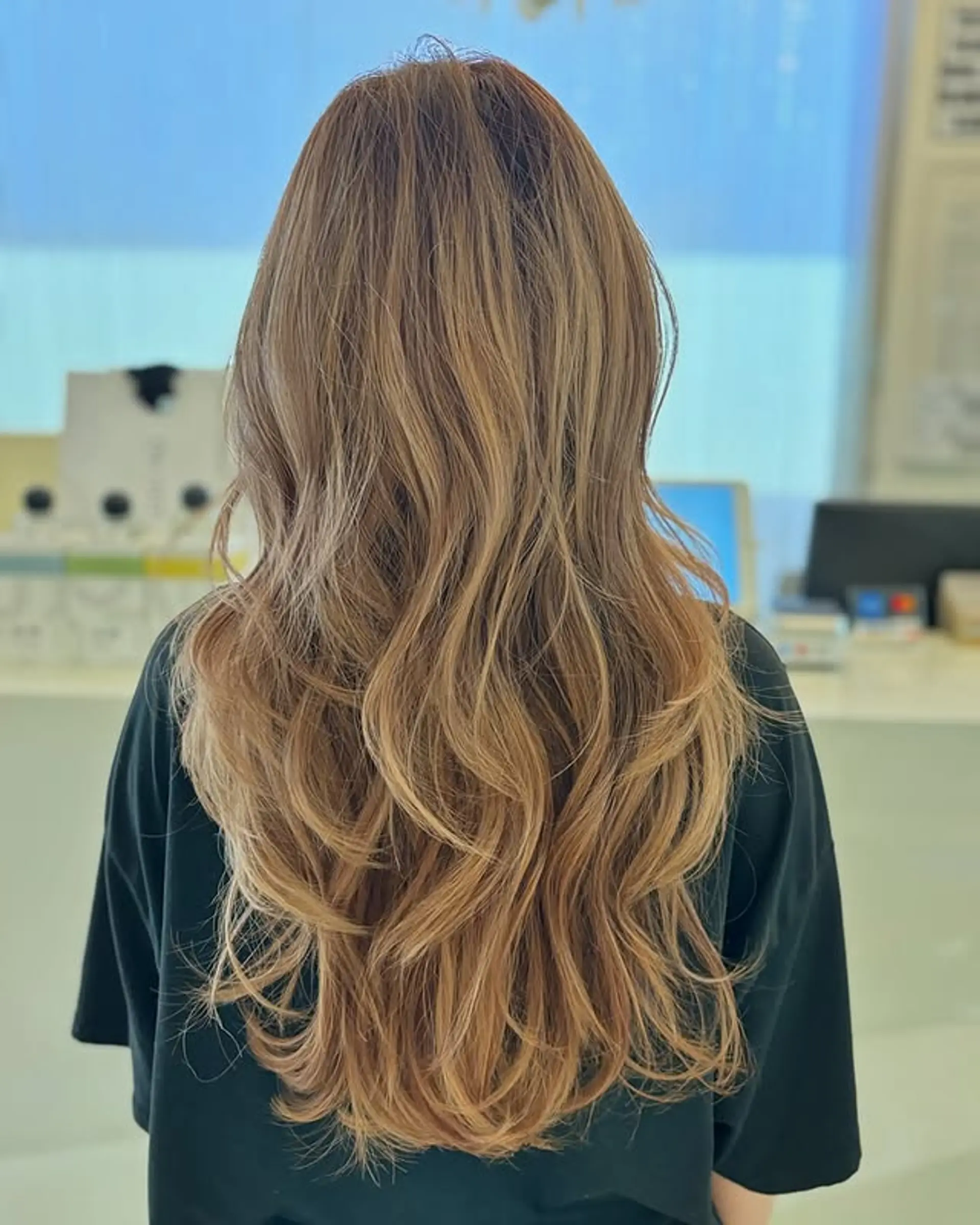 A long, layered wavy hairstyle with soft, flowing waves. 1