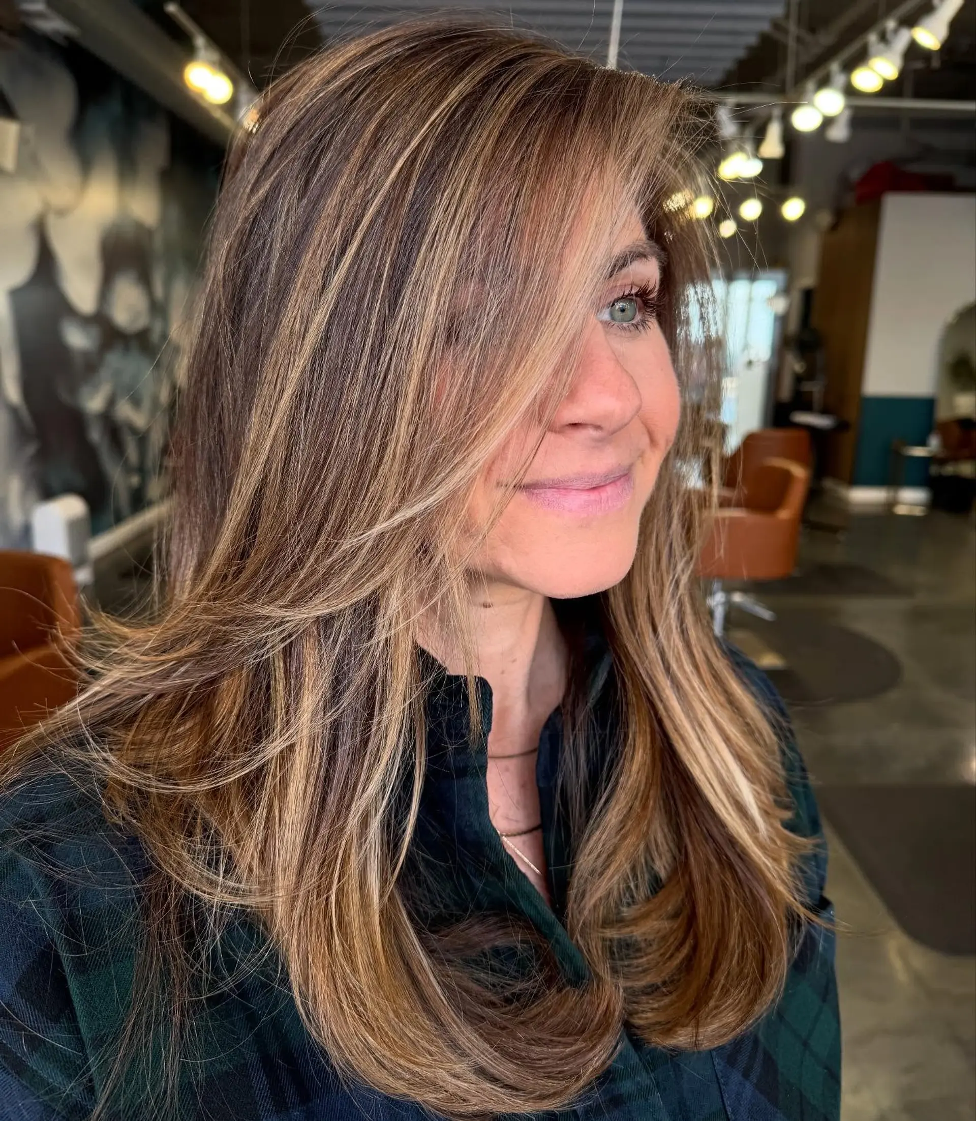 A trendy layered cut with face framing layers and highlights. 1