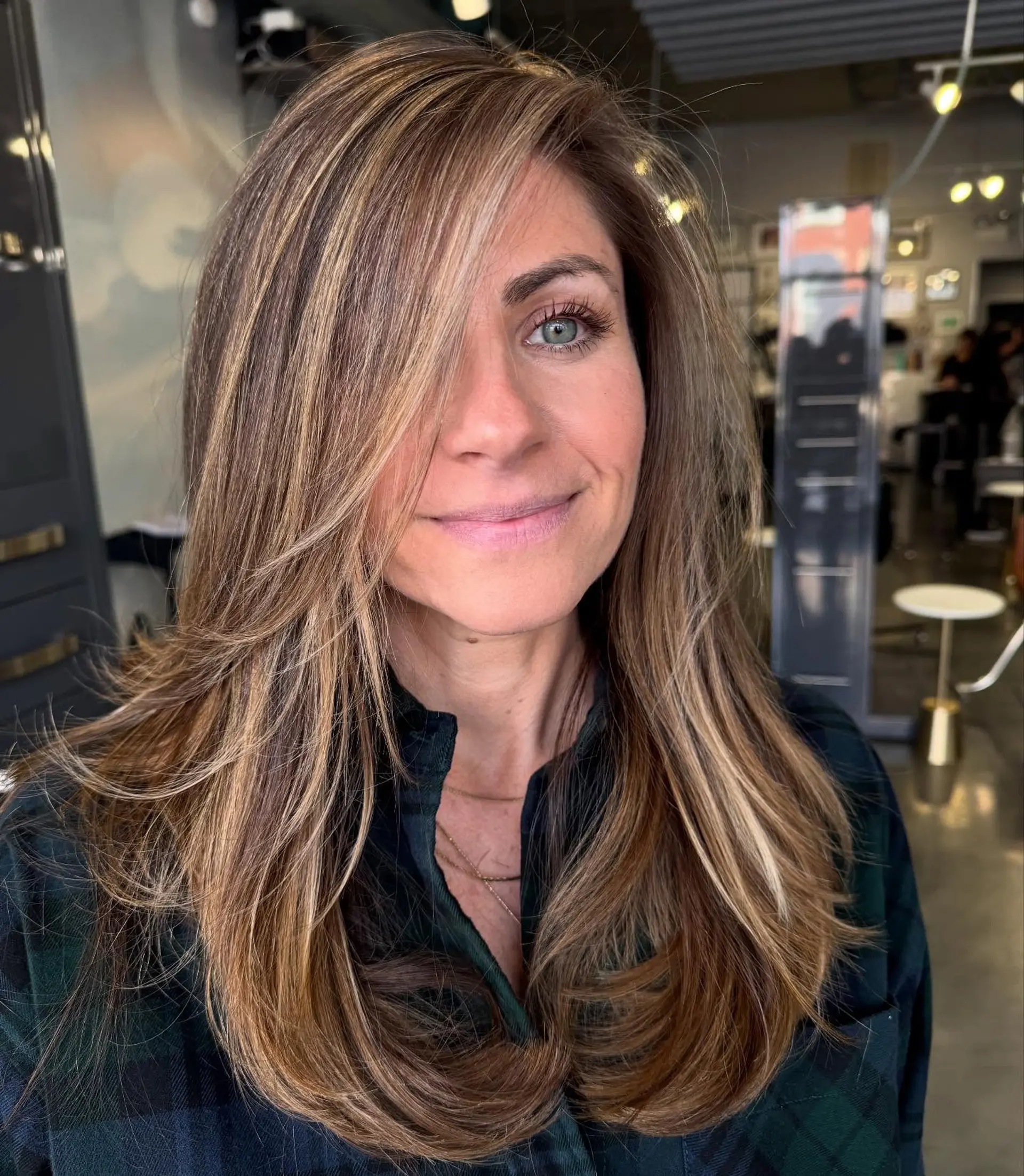 A trendy layered cut with face framing layers and highlights. 2