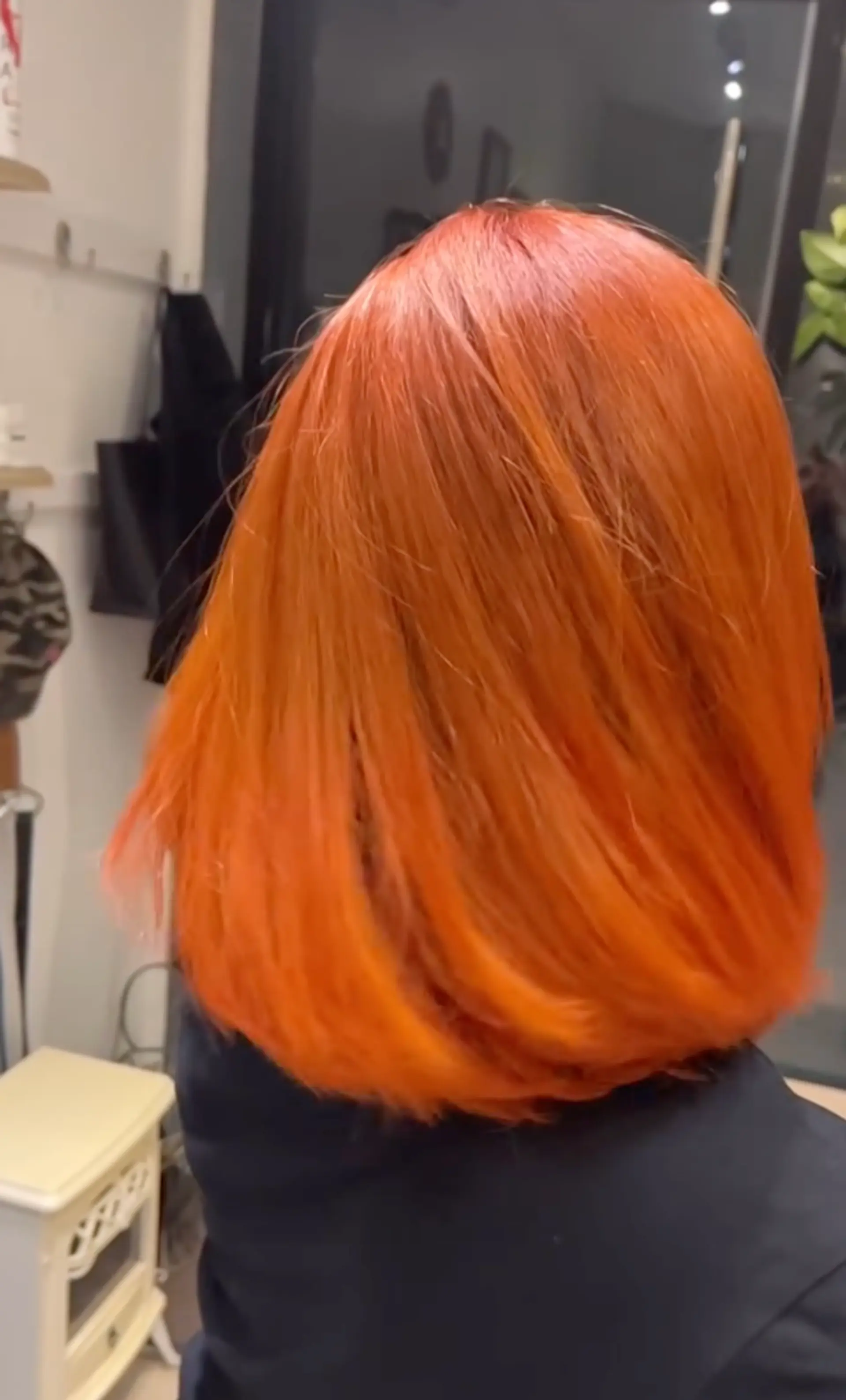 A medium-length, straight bob haircut featuring a vibrant copper color. 1