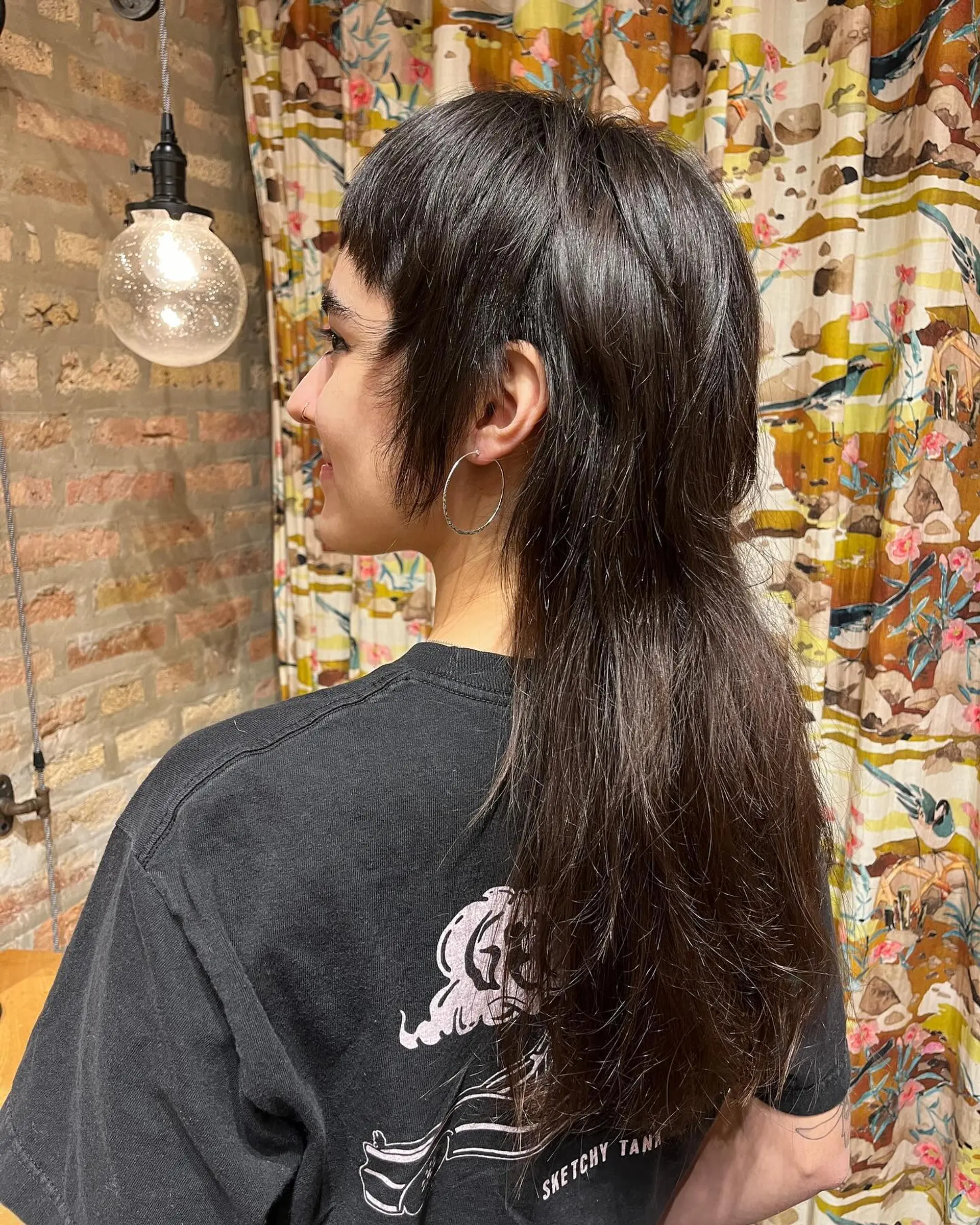 A modern shag mullet with choppy layers and short baby bangs. 2