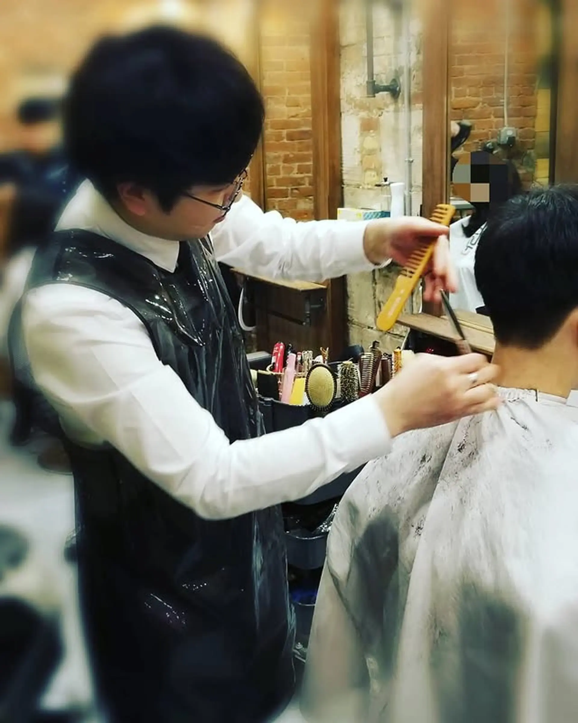 A short, clean taper fade hairstyle. 1