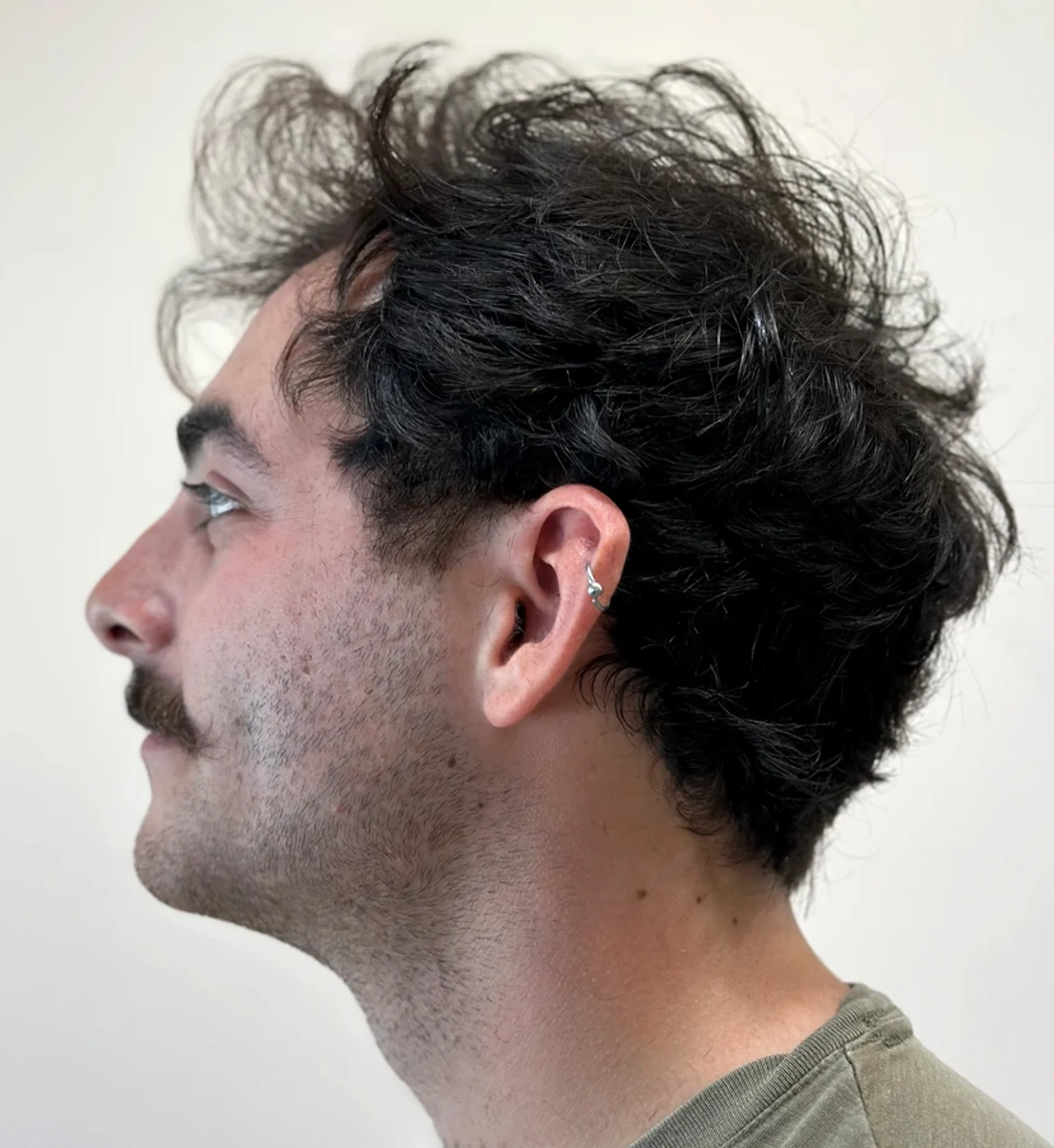Medium-length curly hair styled in a relaxed bro flow with a naturally tapered neckline - Preview 2