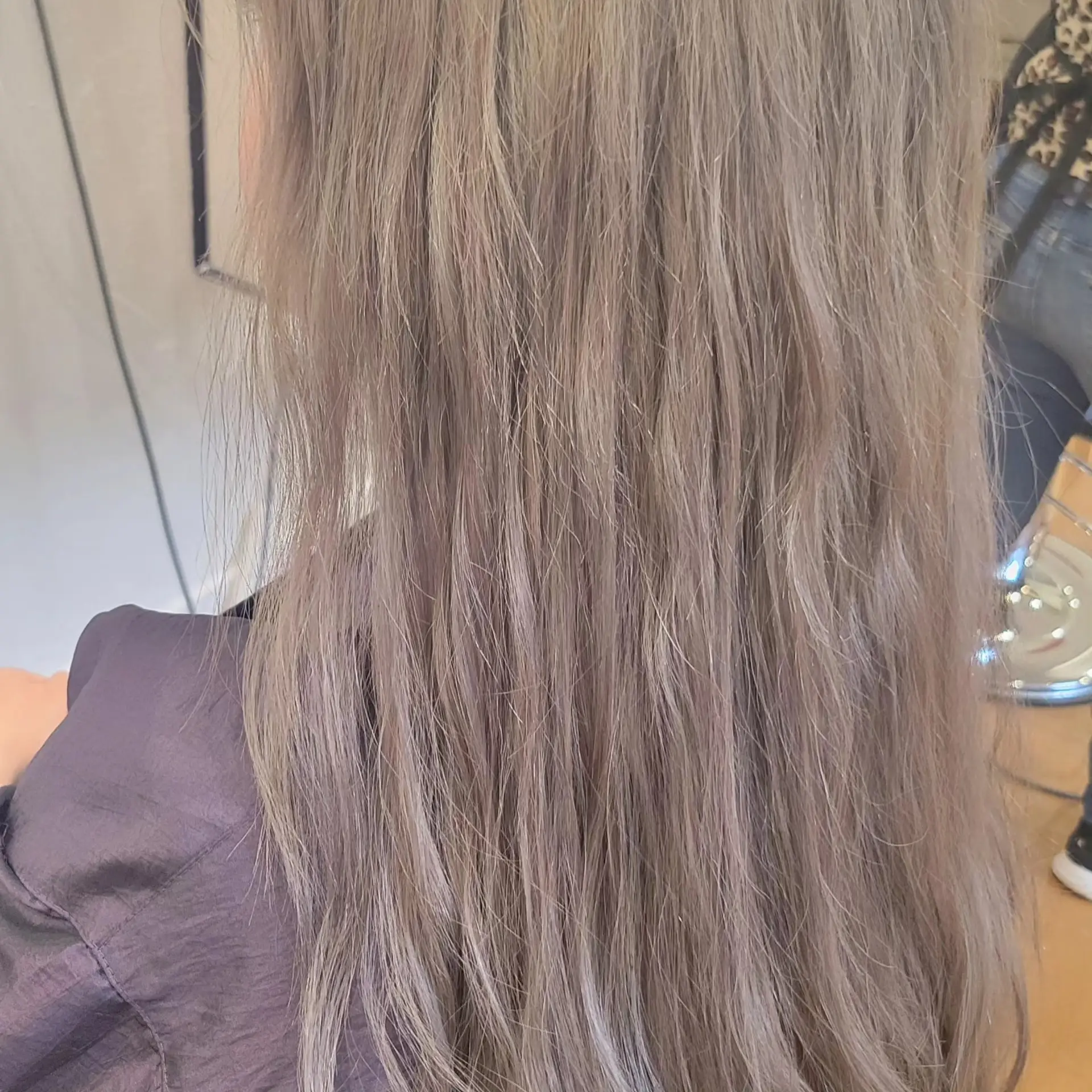 Long hair styled with gentle natural waves in a cool-toned ash beige shade. 1