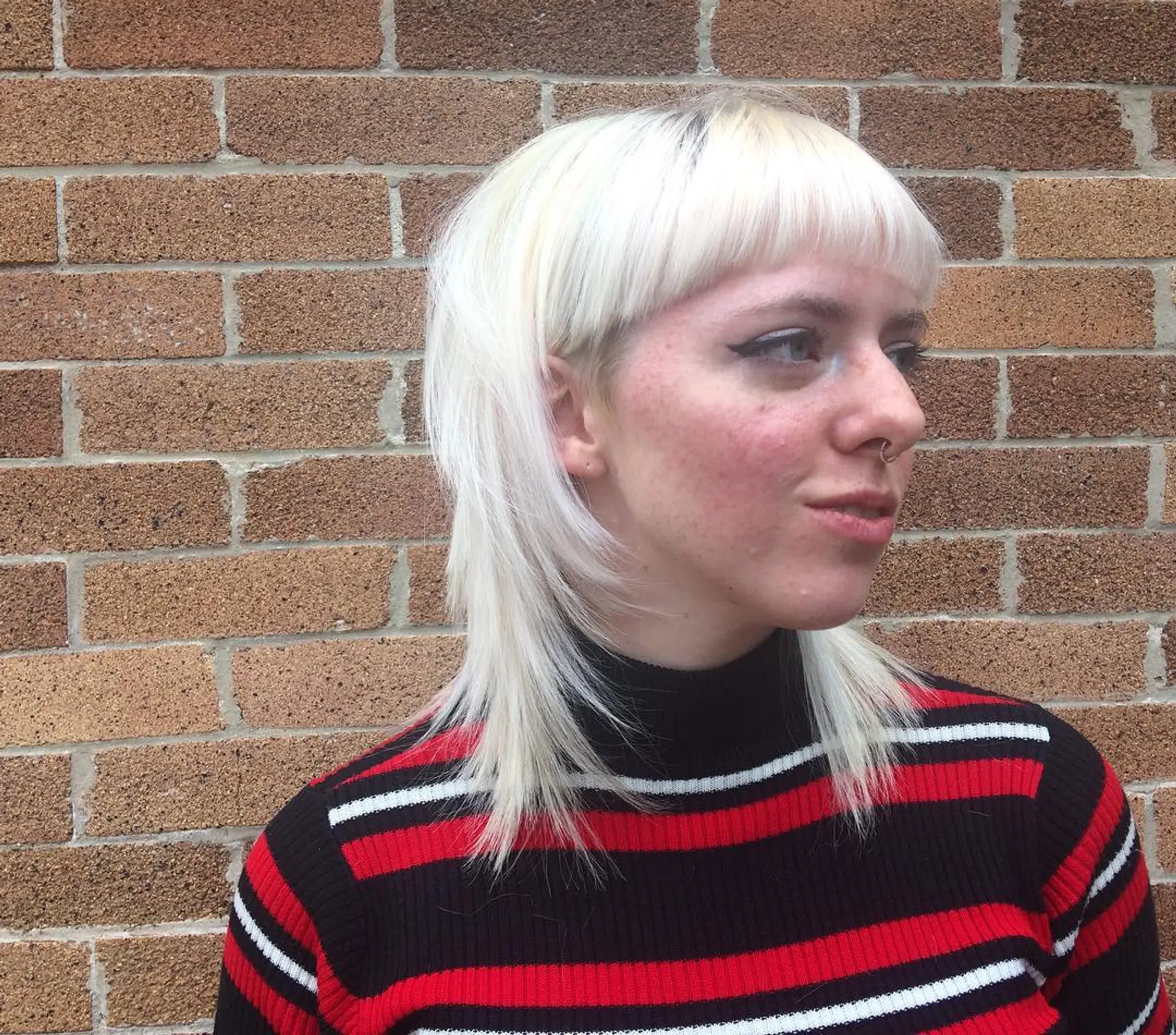 A layered shag haircut with super short, baby bangs. 1