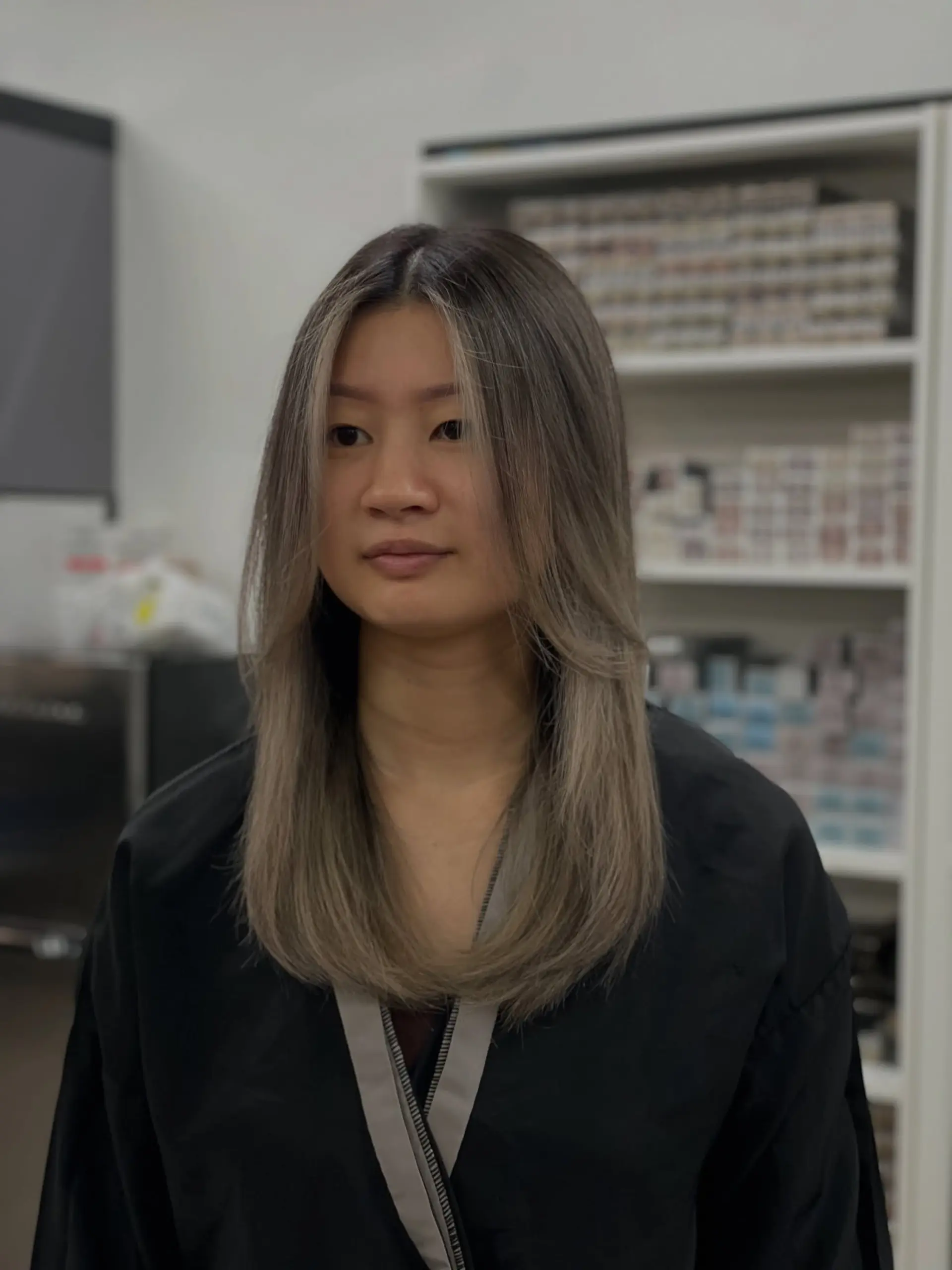 A layered, medium-length hairstyle with face-framing layers and money piece highlights. 1