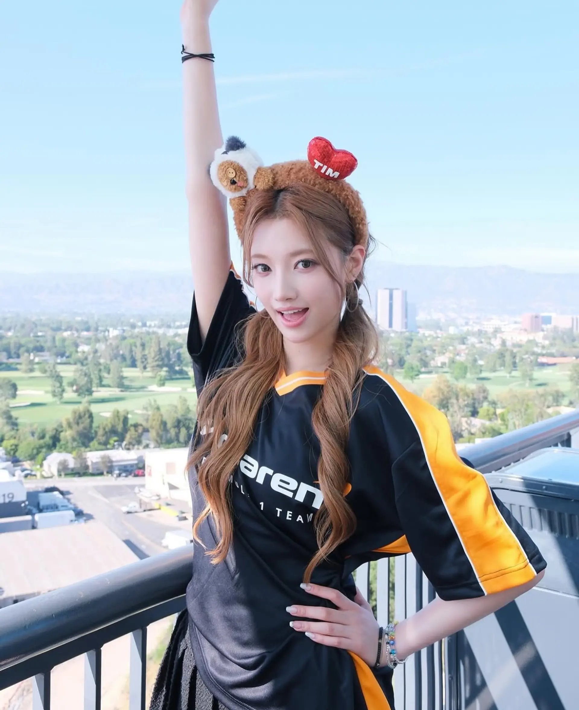 This hairstyle features long wavy hair styled into double ponytails. 1