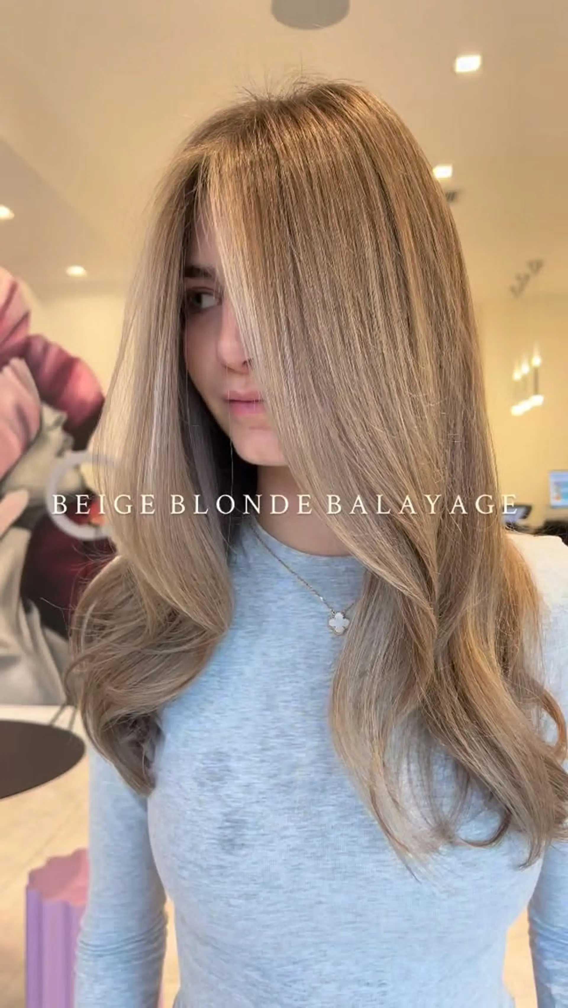 Long beige blonde balayage styled into a smooth, voluminous blowout with gentle curved ends and face-framing layers. 1