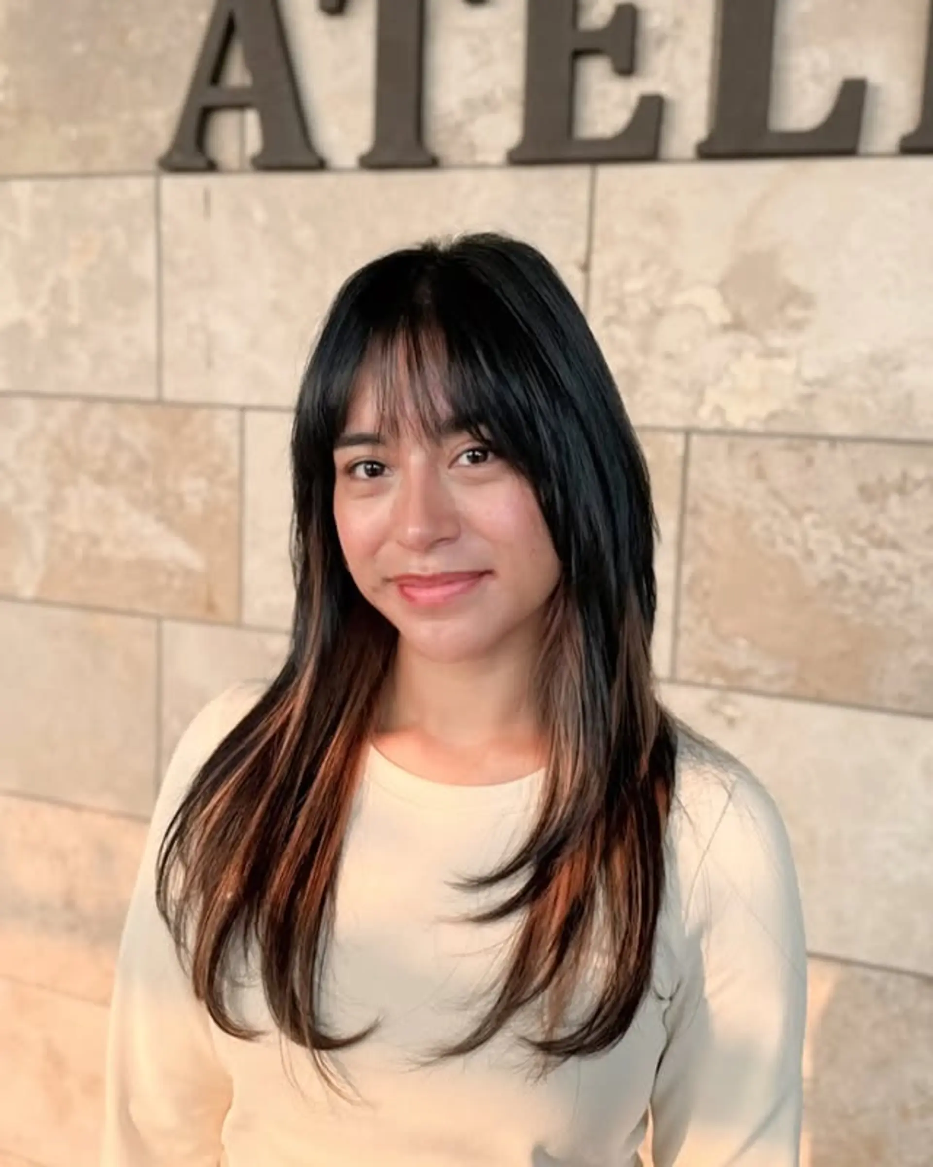 A long layered shag with curtain bangs and subtle balayage. 1