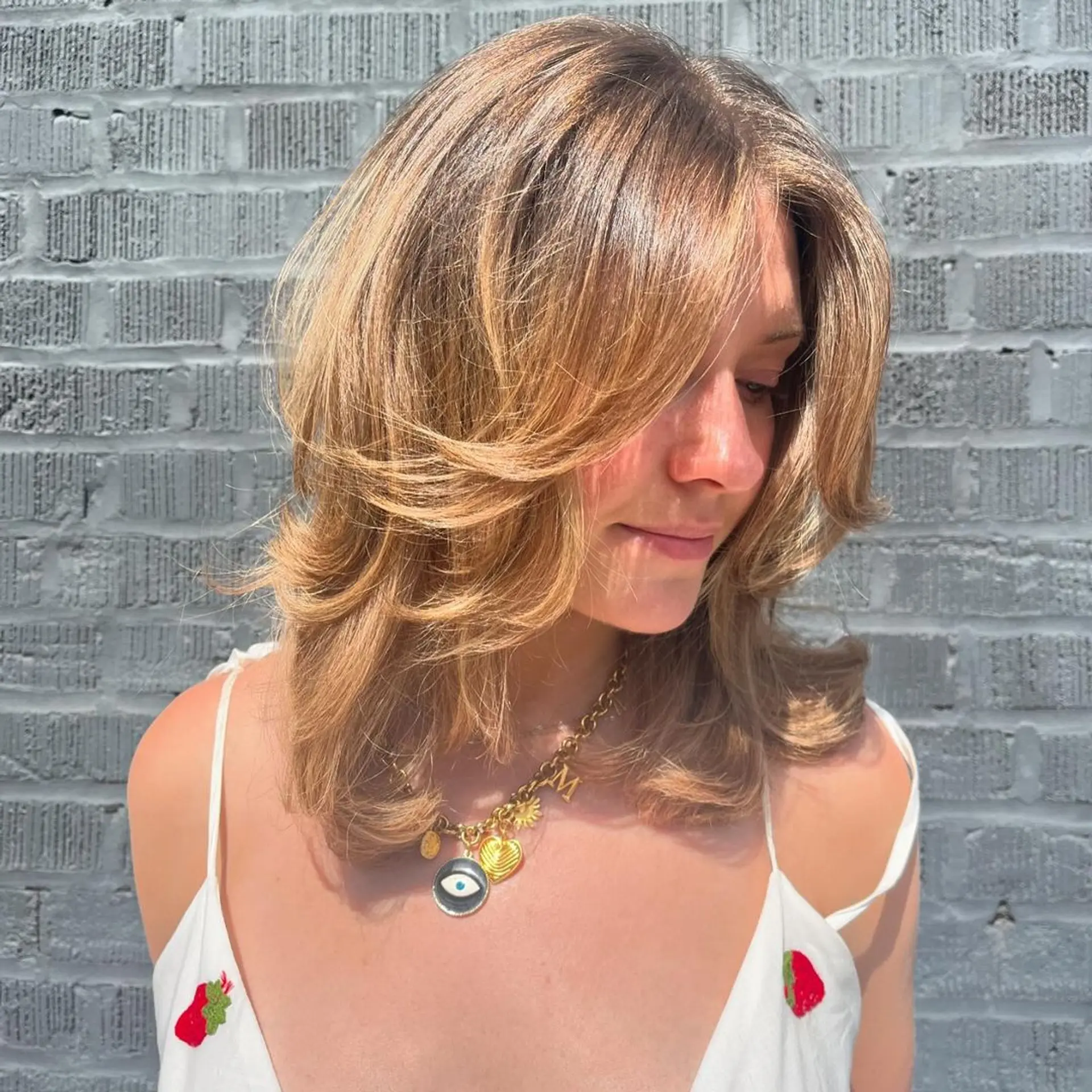 Medium length, honey blonde waves with feathered, face-framing layers and side-swept bangs.

versatile cut to have a beautiful shape both curly and straight ✨🌟💫 1