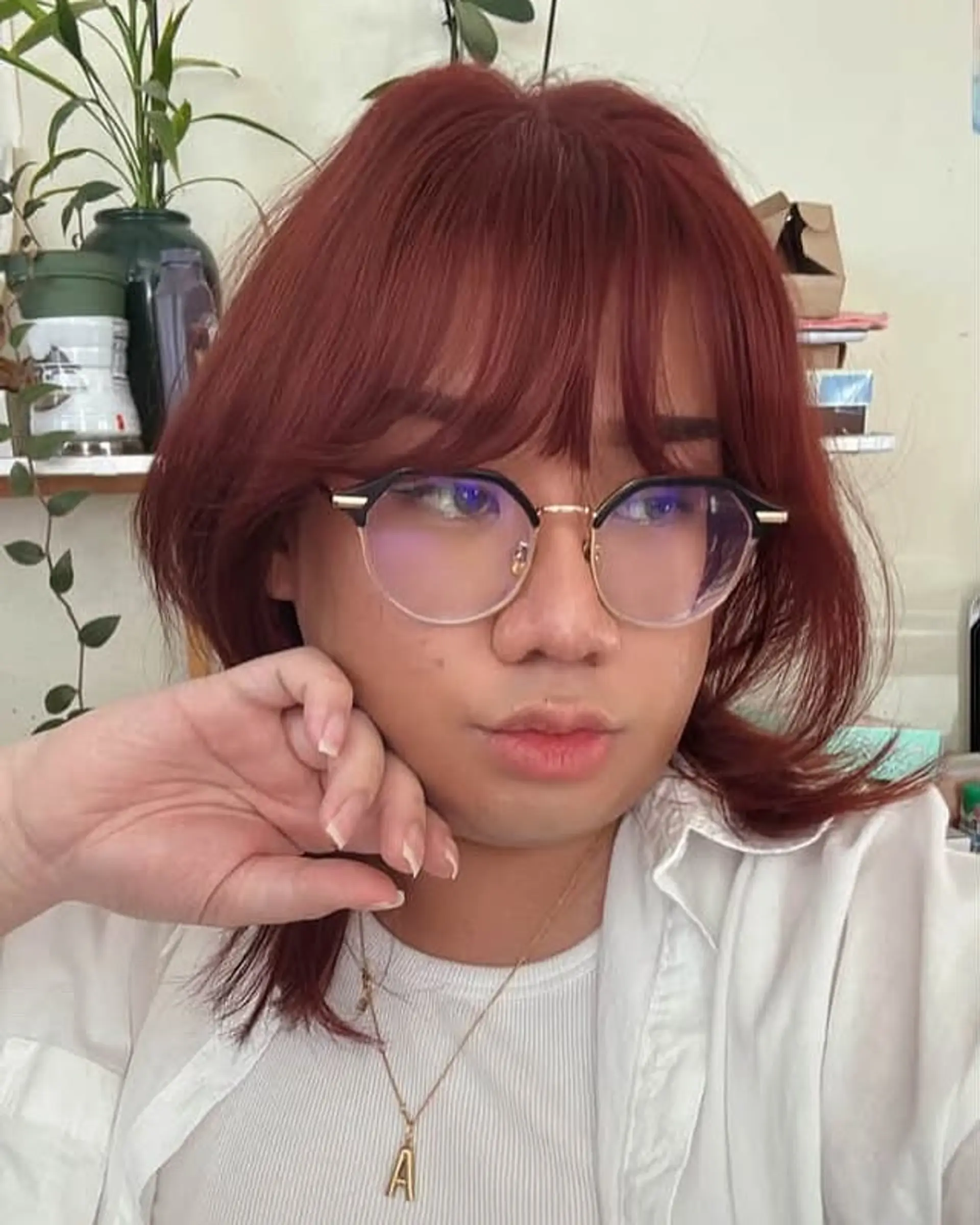 A trendy medium-length shag haircut with face-framing bangs. 1