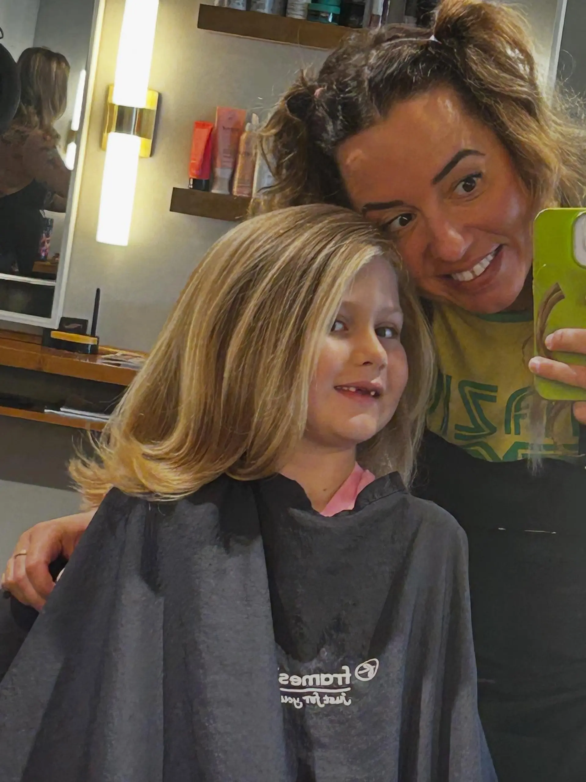 A full, voluminous blowout on medium-length golden hair featuring a side sweep and soft upward-flipped ends. 1