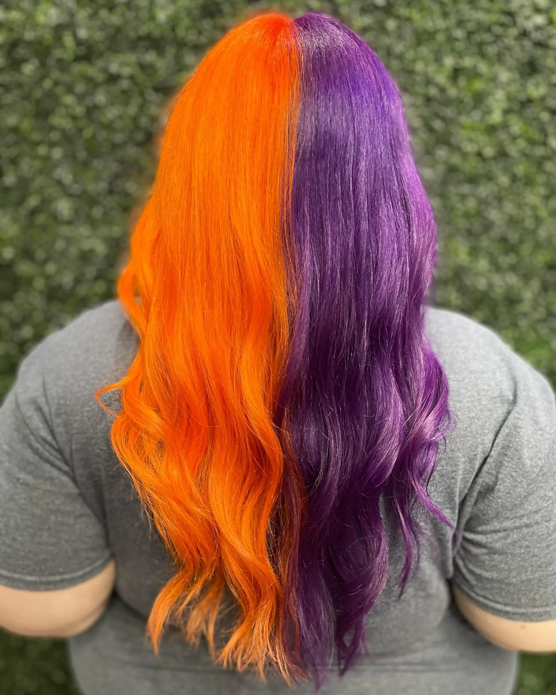 A bold split dye featuring vivid electric orange on one half and deep royal purple on the other, finished with soft waves. 1