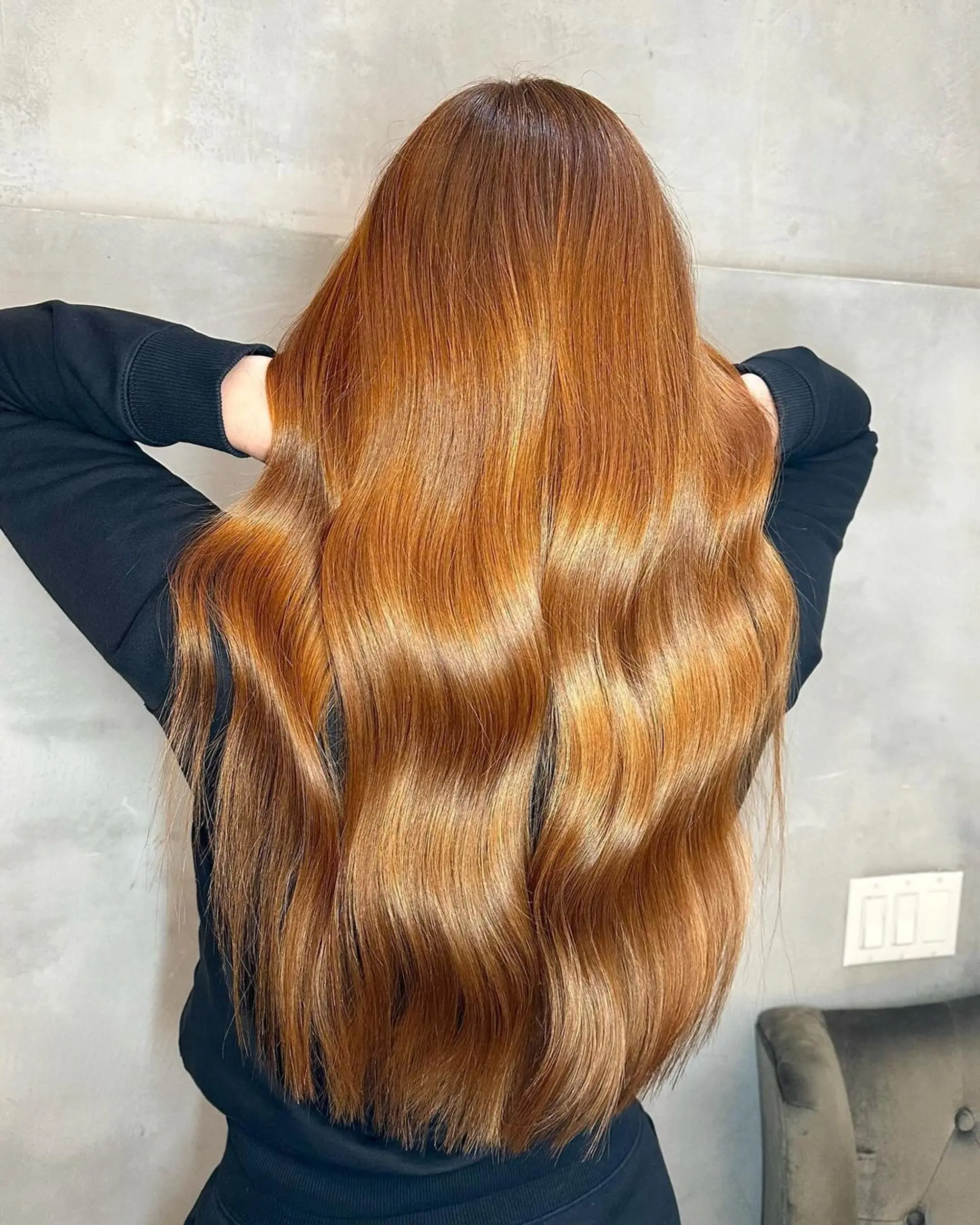 Very long, wavy, and glossy hair with a blend of copper and golden blonde hues, featuring natural layers that promote a flowing, radiant look. 1