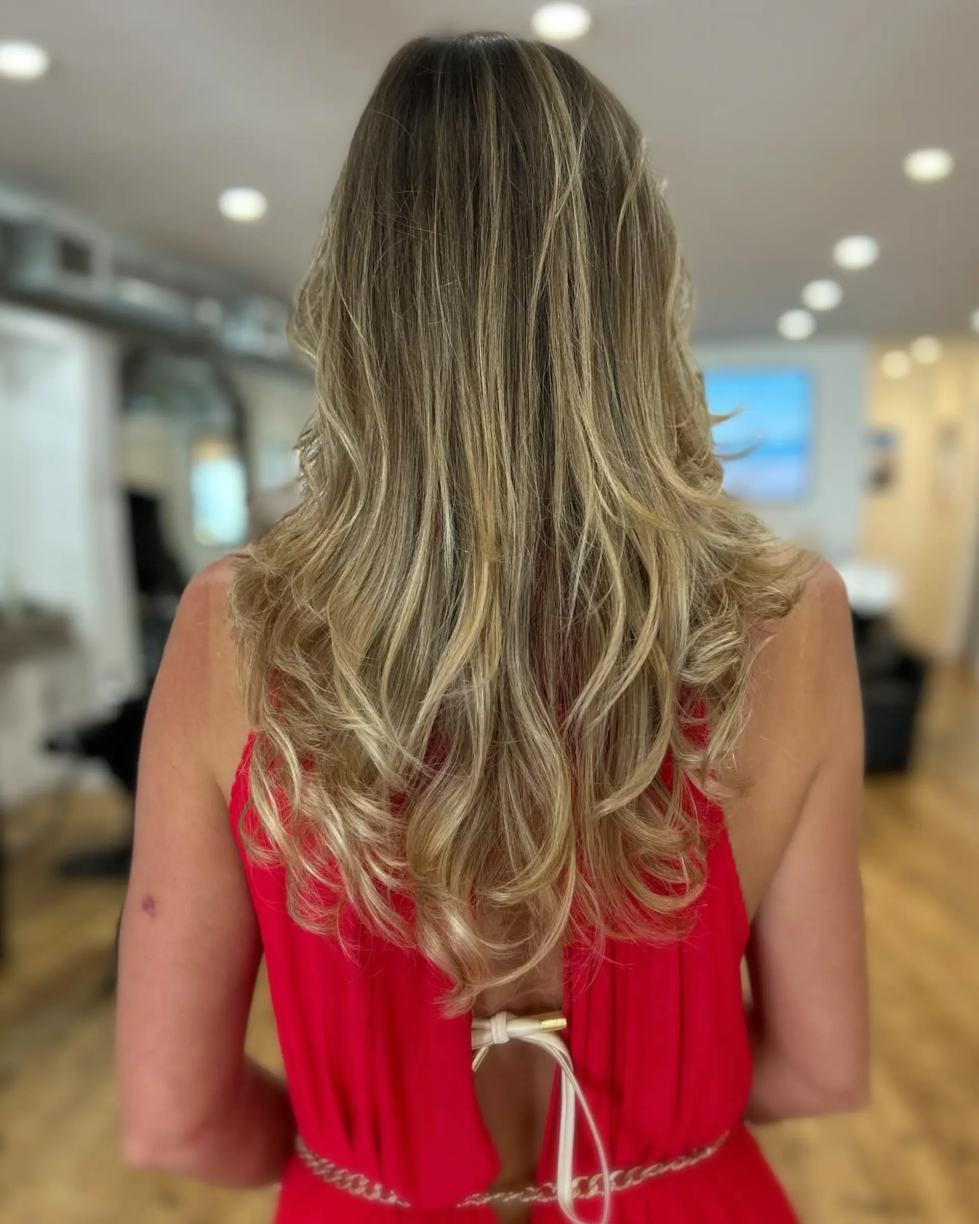 Long, layered hairstyle with a soft, wavy texture and face framing layers. 2