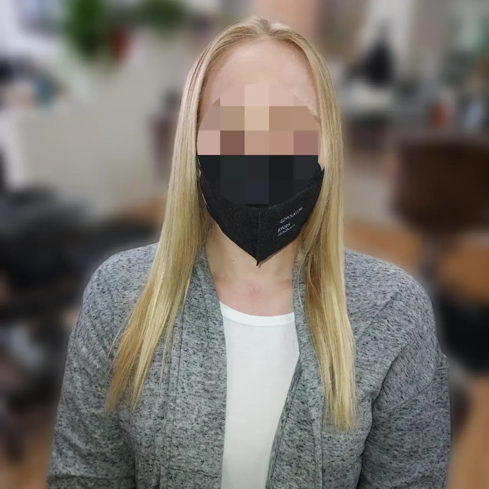 Smooth, sleek straight blonde hair parted in the middle and falling naturally over the shoulders. 1