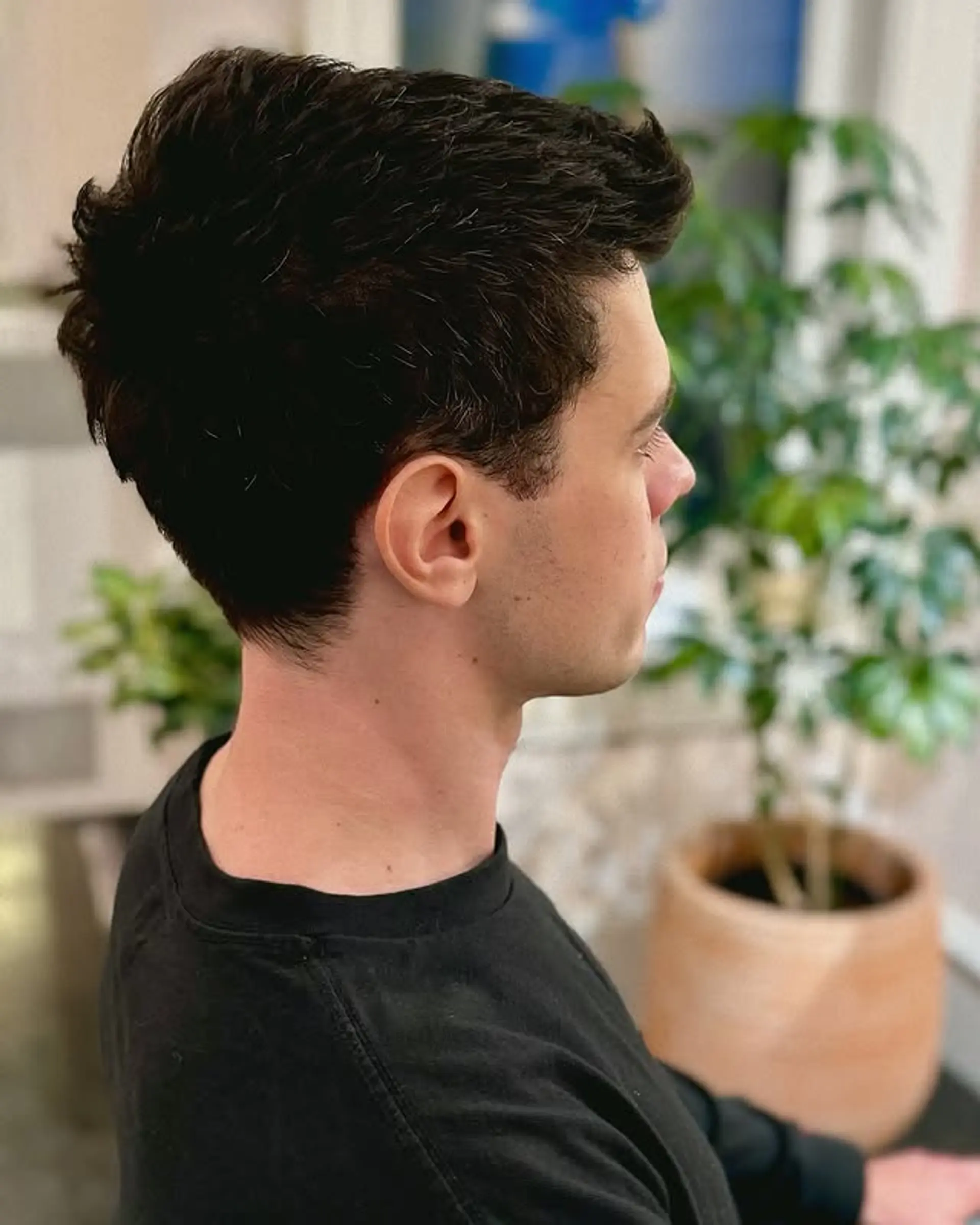 This men's hairstyle features a textured top with neatly tapered and faded sides and back, creating a clean, modern, and versatile look. Ideal for a polished yet effortless aesthetic. 1
