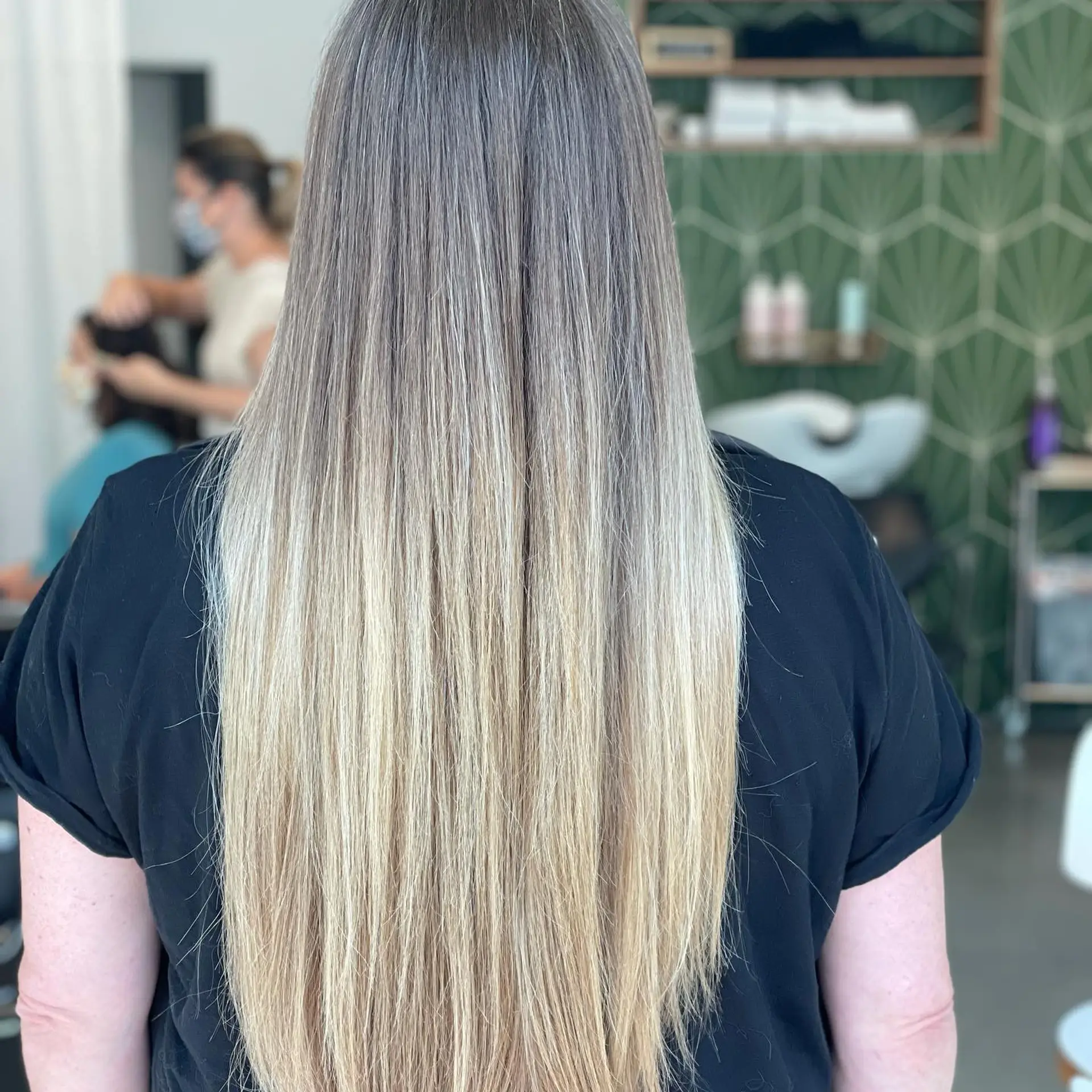 Very long, smooth straight hair featuring a seamless balayage gradient from ash-toned roots to bright blonde ends. 1