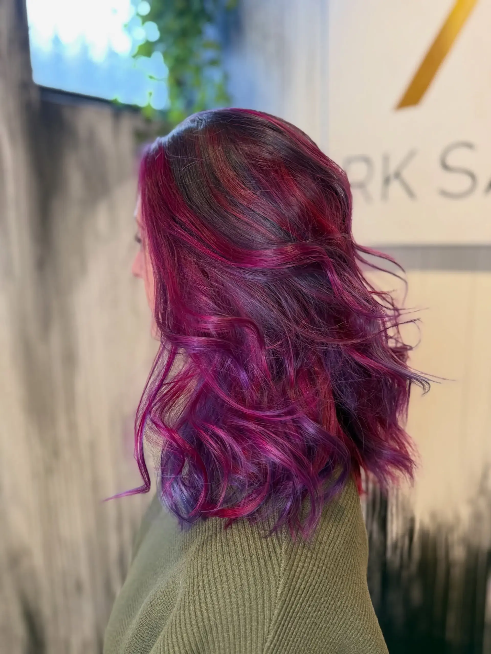 Medium-length textured cut styled in loose, dimensional waves with vibrant magenta, violet, and deep purple tones. 1