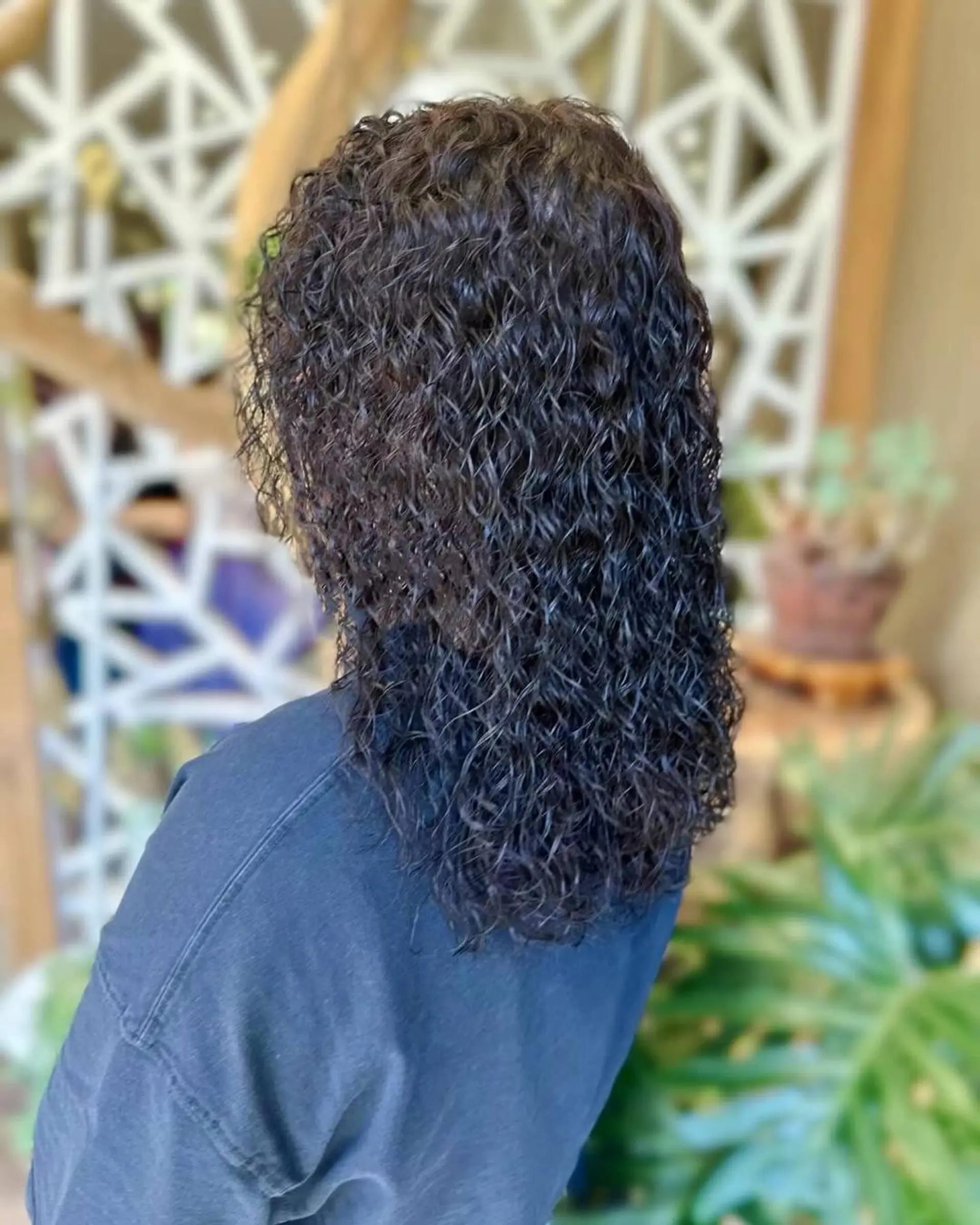 A shoulder-length hairstyle with defined natural curls. 1