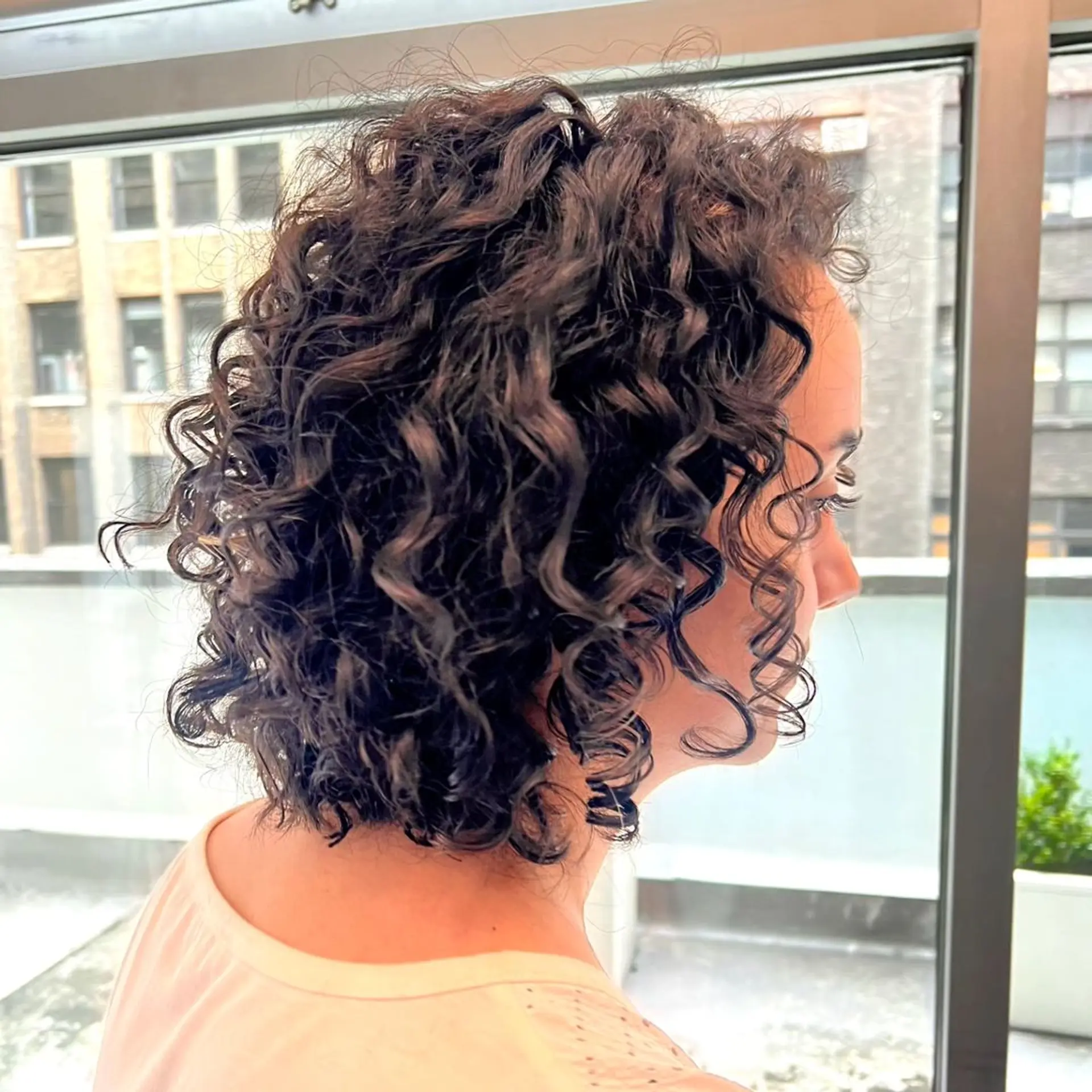 Medium-length, dark brown curls that are defined into neat, voluminous ringlets with a casual yet sophisticated look. 1