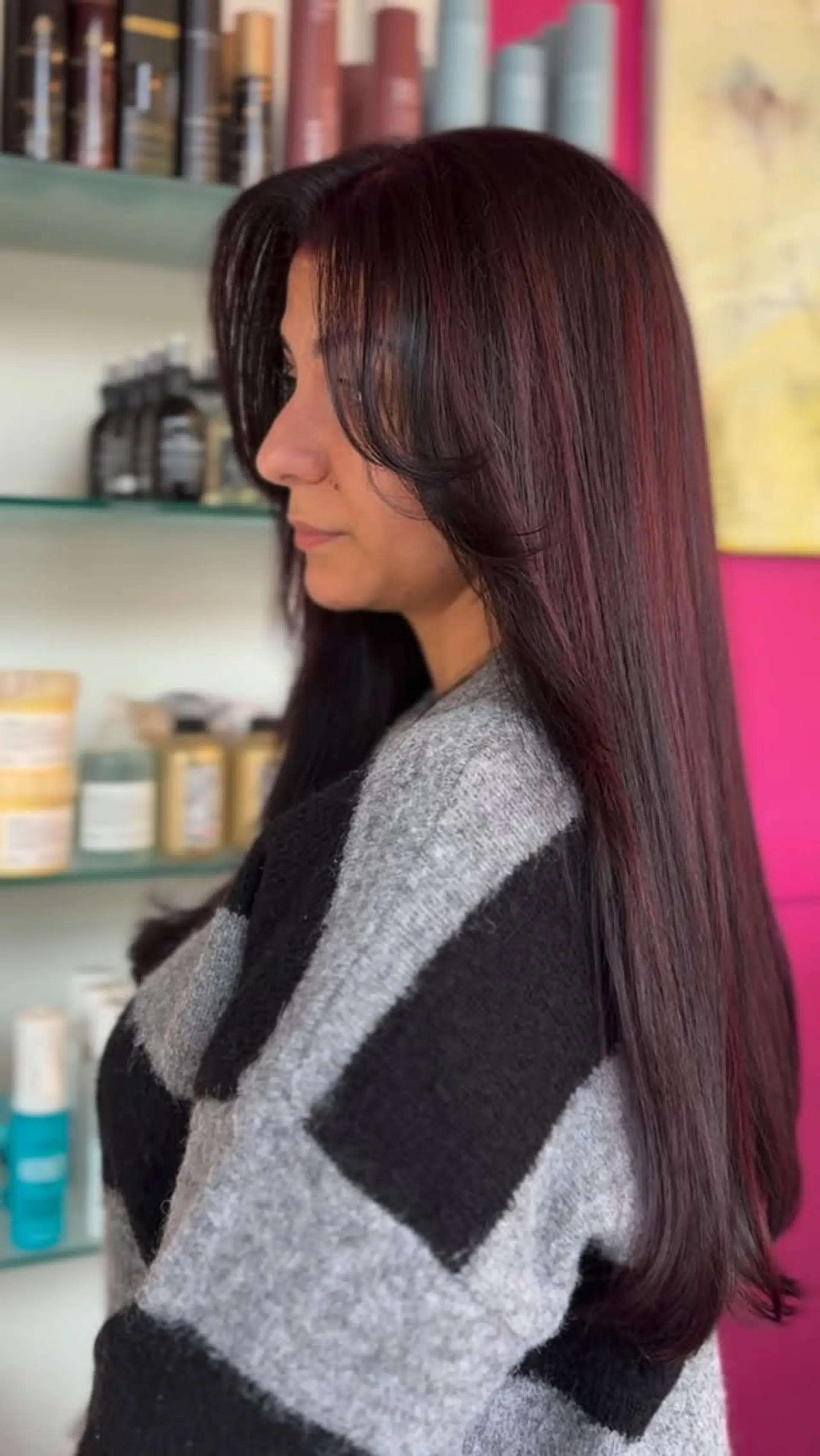 Long straight dark hair with dimensional deep cherry red tones and curved face-framing bangs. 1