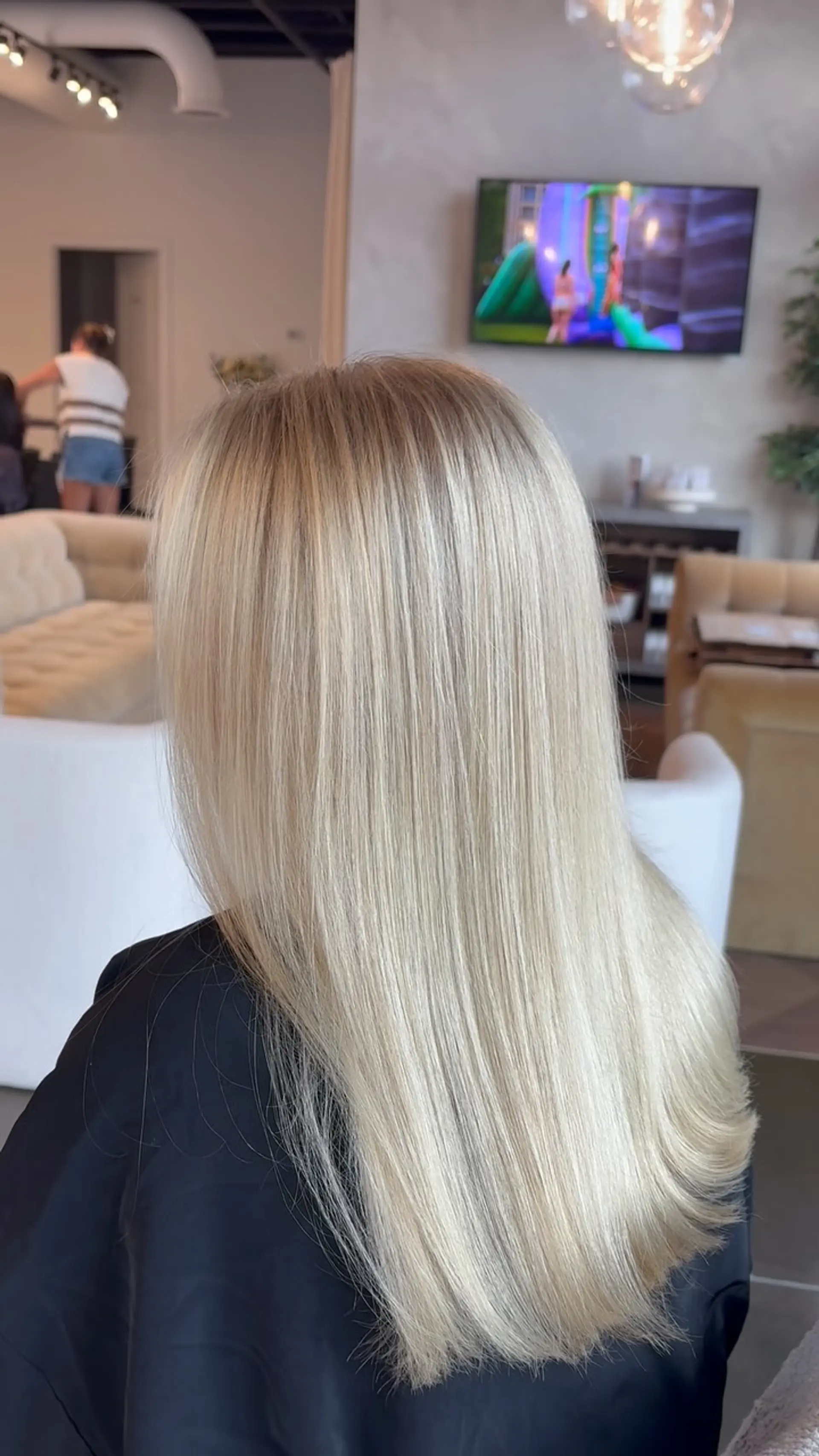 Straight, bright blonde hair styled with a smooth, glossy blowout and subtly beveled ends. 1