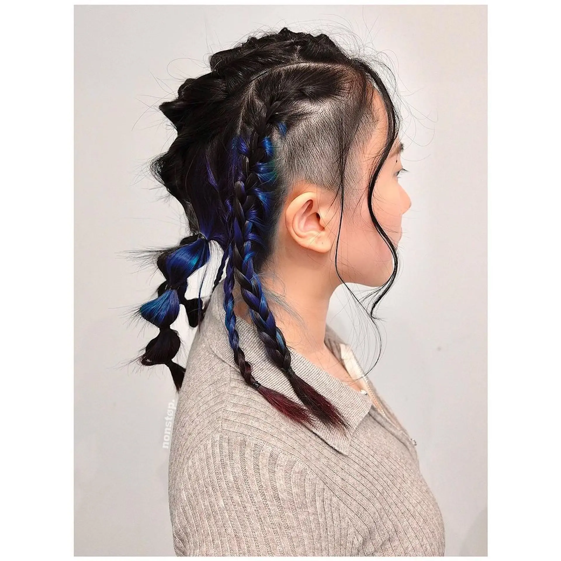 A bold undercut on one side with braided sections in black, blue, and purple intertwining. Loose ends of the braids are twisted for added dimension, while the hair on the other side is left down and smooth.

Hair color by VINCENT🌌Hairbrained by YUKI 1